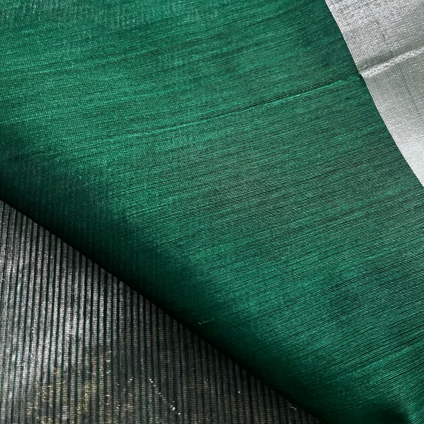Dark green Maheshwari saree with silver zari lines all over