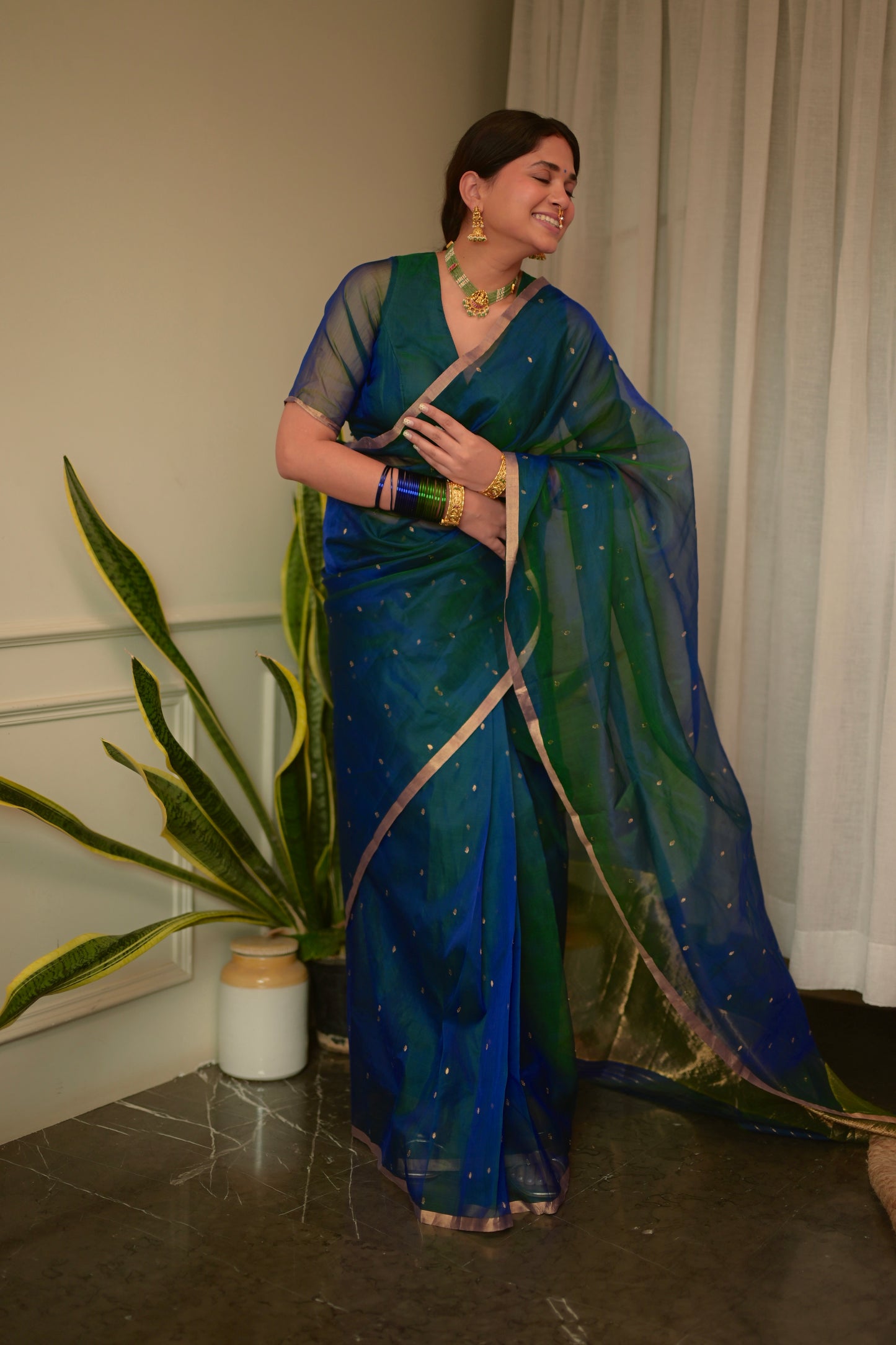 Peacock blue and green dual tone Chanderi organza silk saree with zari bootis all over