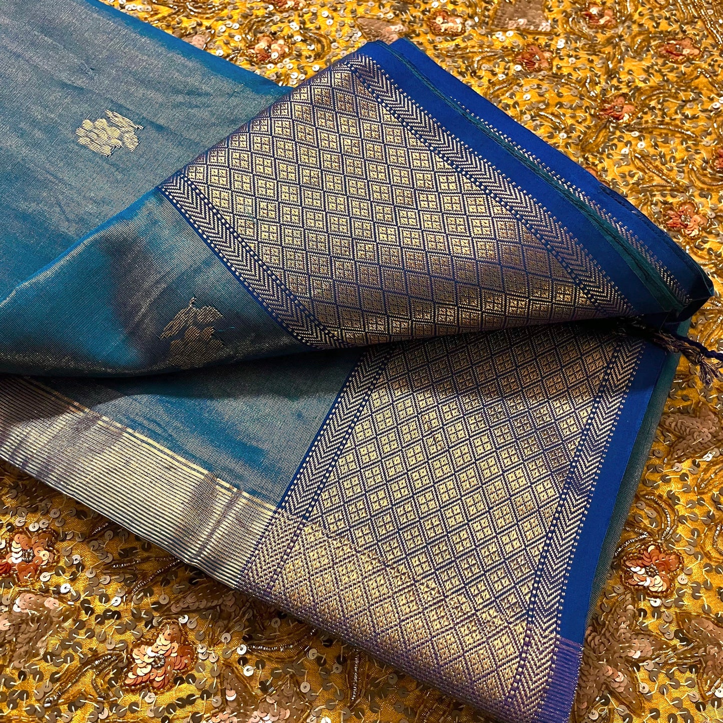 Peacock blue maheshwari tissue silk saree with flower motifs all over