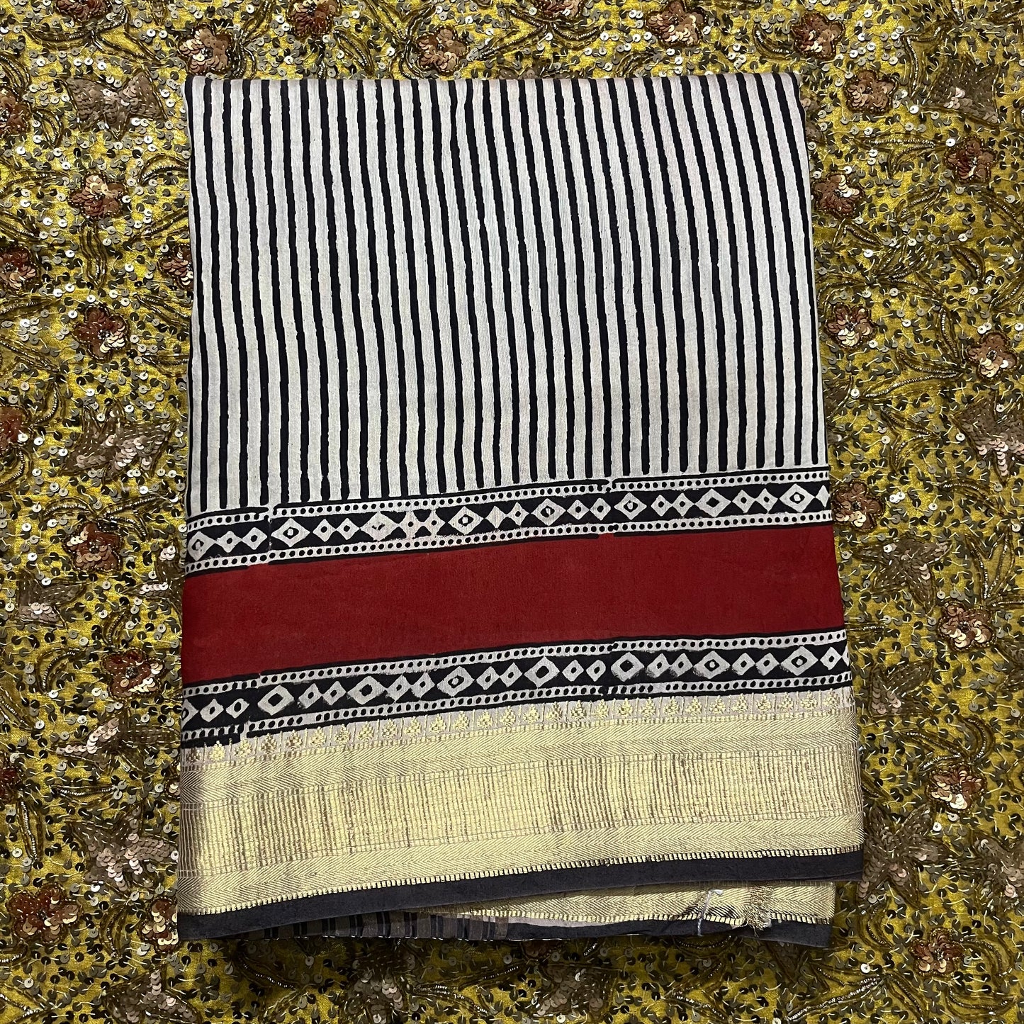 Black and white silk saree with block print all over and zari border