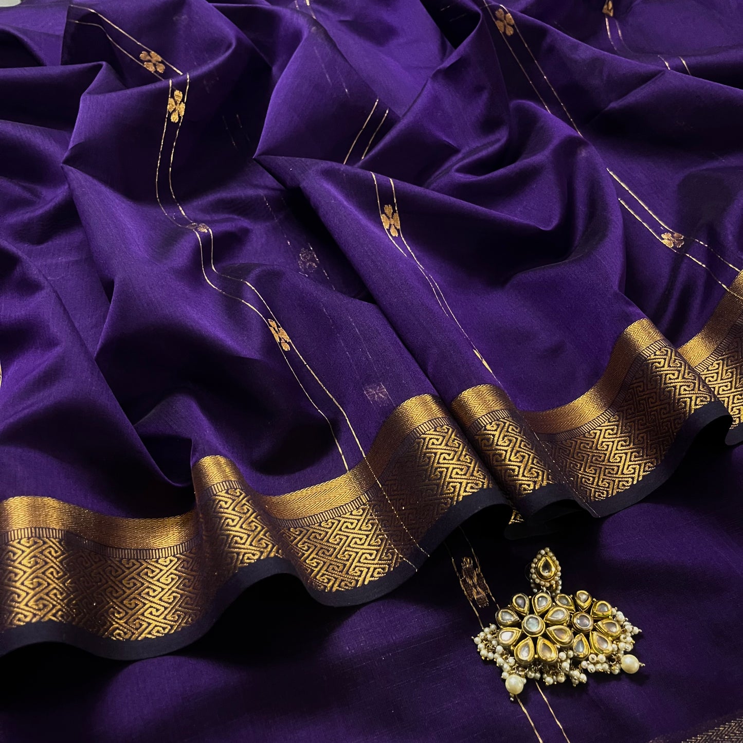 Dark purple Maheshwari saree with dori flower bootis all over