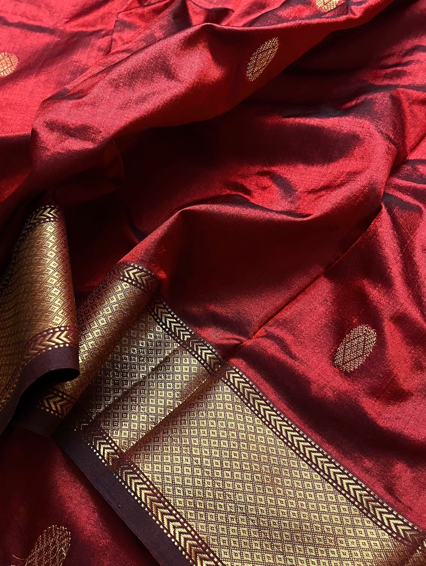 Deep maroon Maheshwari silk saree with zari bootis all over