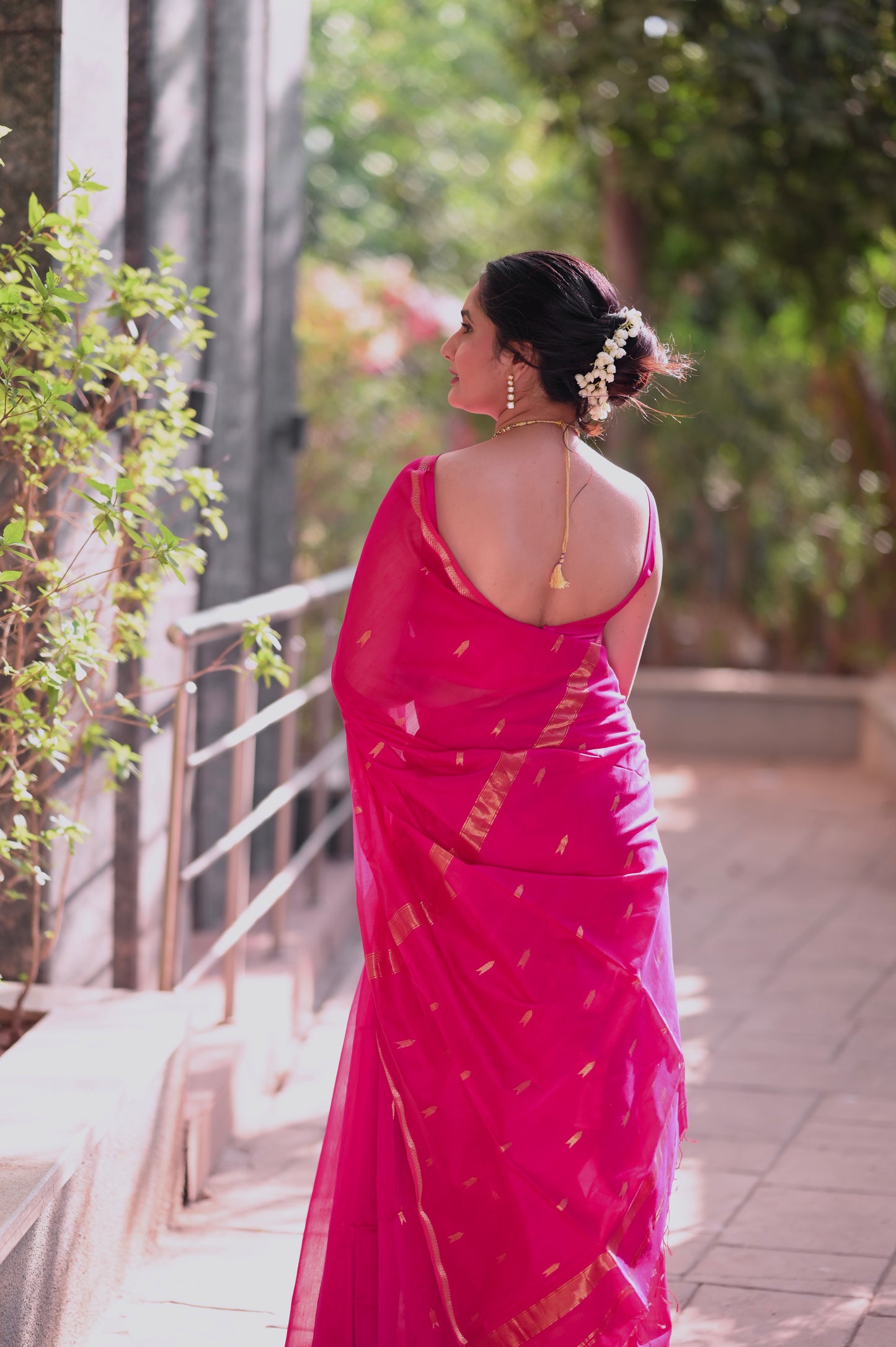 Rani pink maheshwari saree with zari border and zari bootis all over