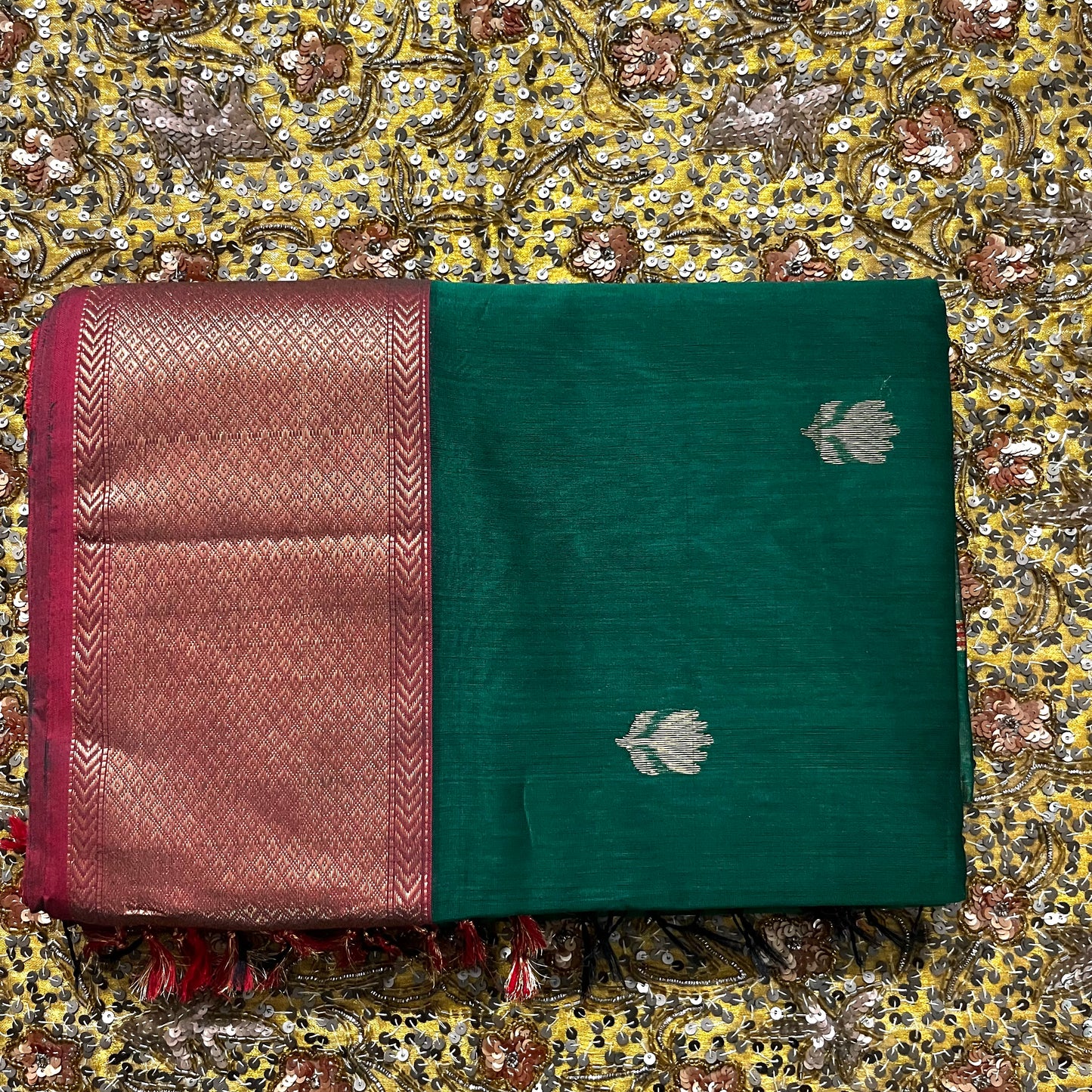 Dark green and red Maheshwari saree with flower motifs all over