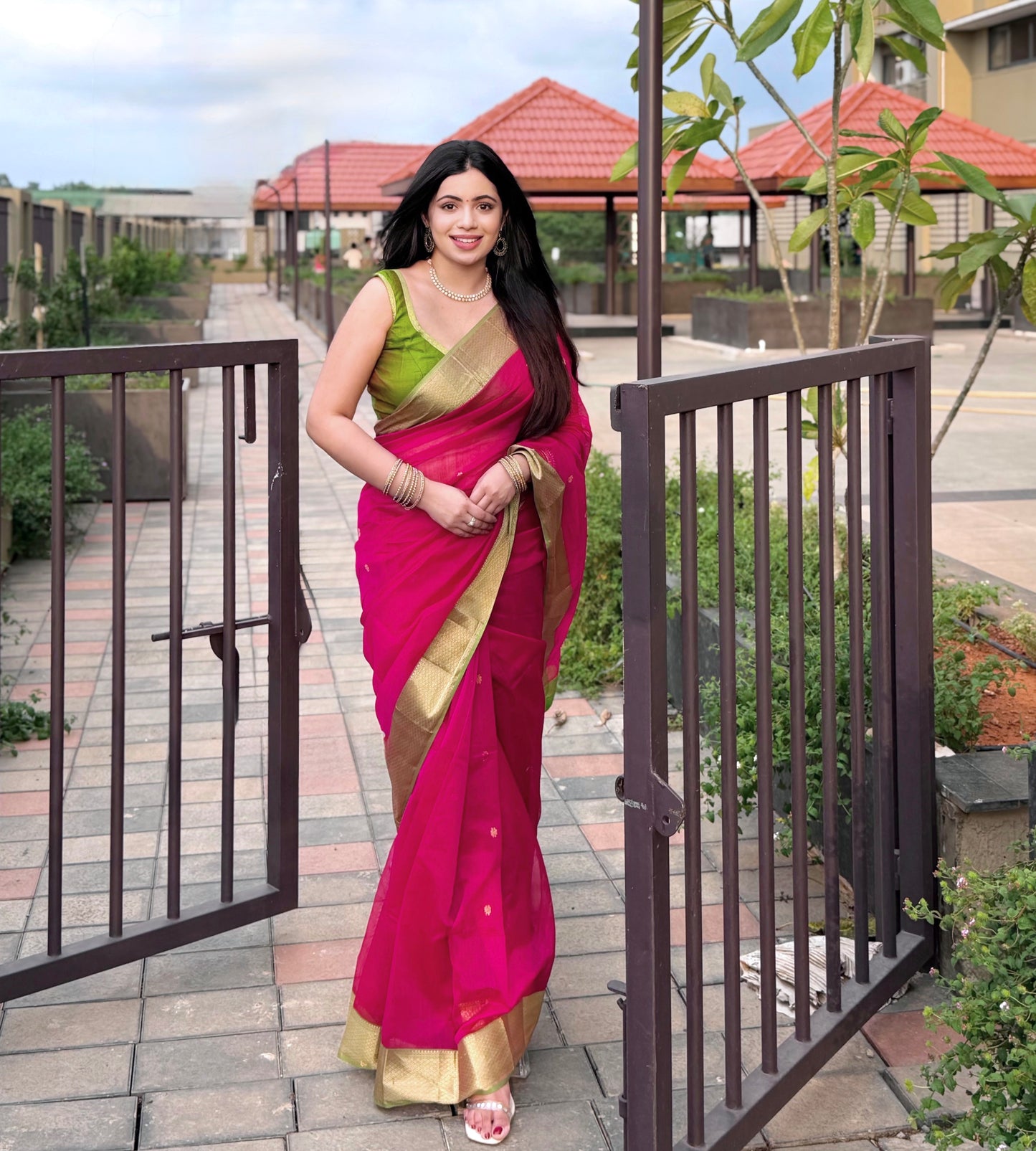 Pink and olive green Maheshwari saree with flower motifs on pallu