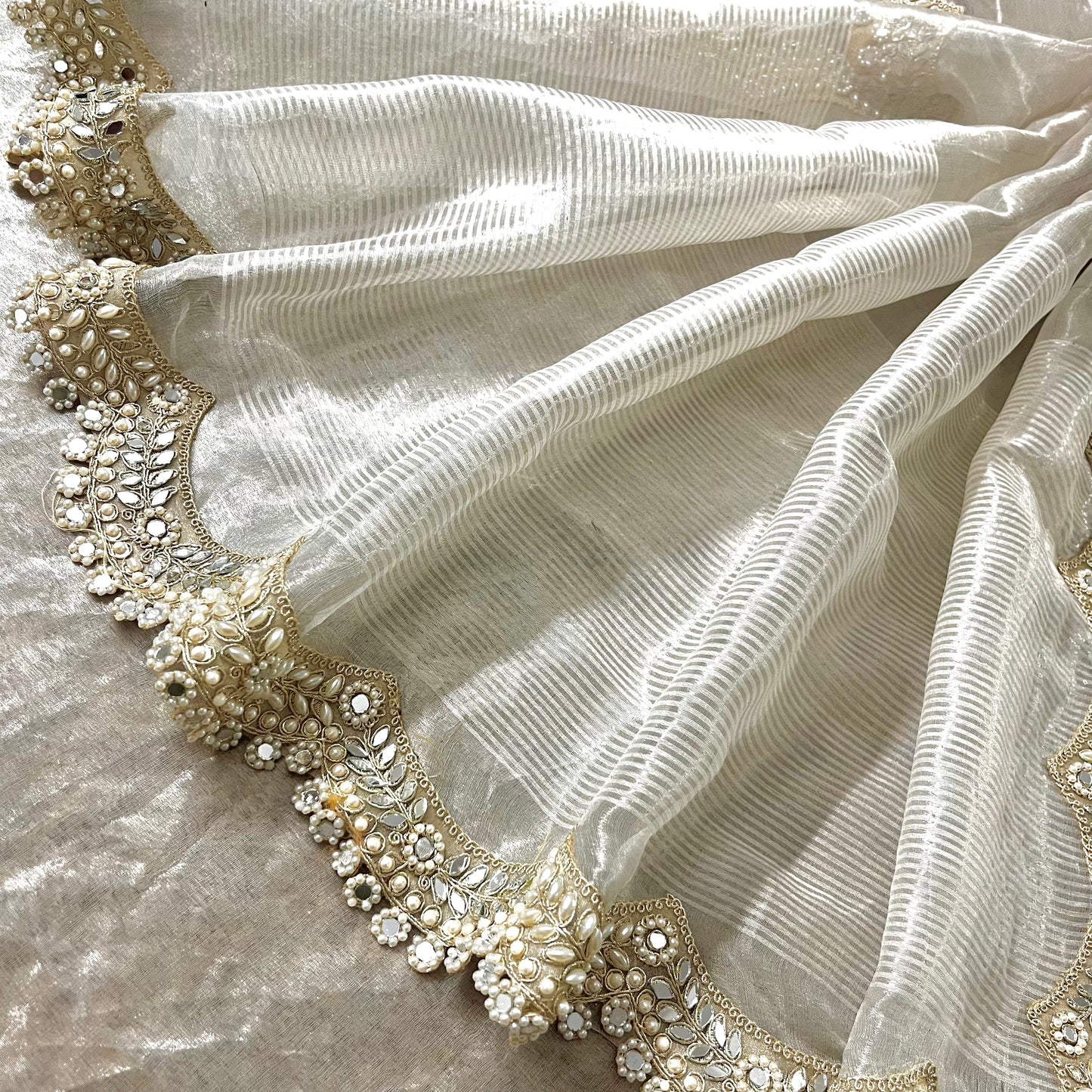 Molten silver chanderi tissue silk saree with pearl and mirror work border