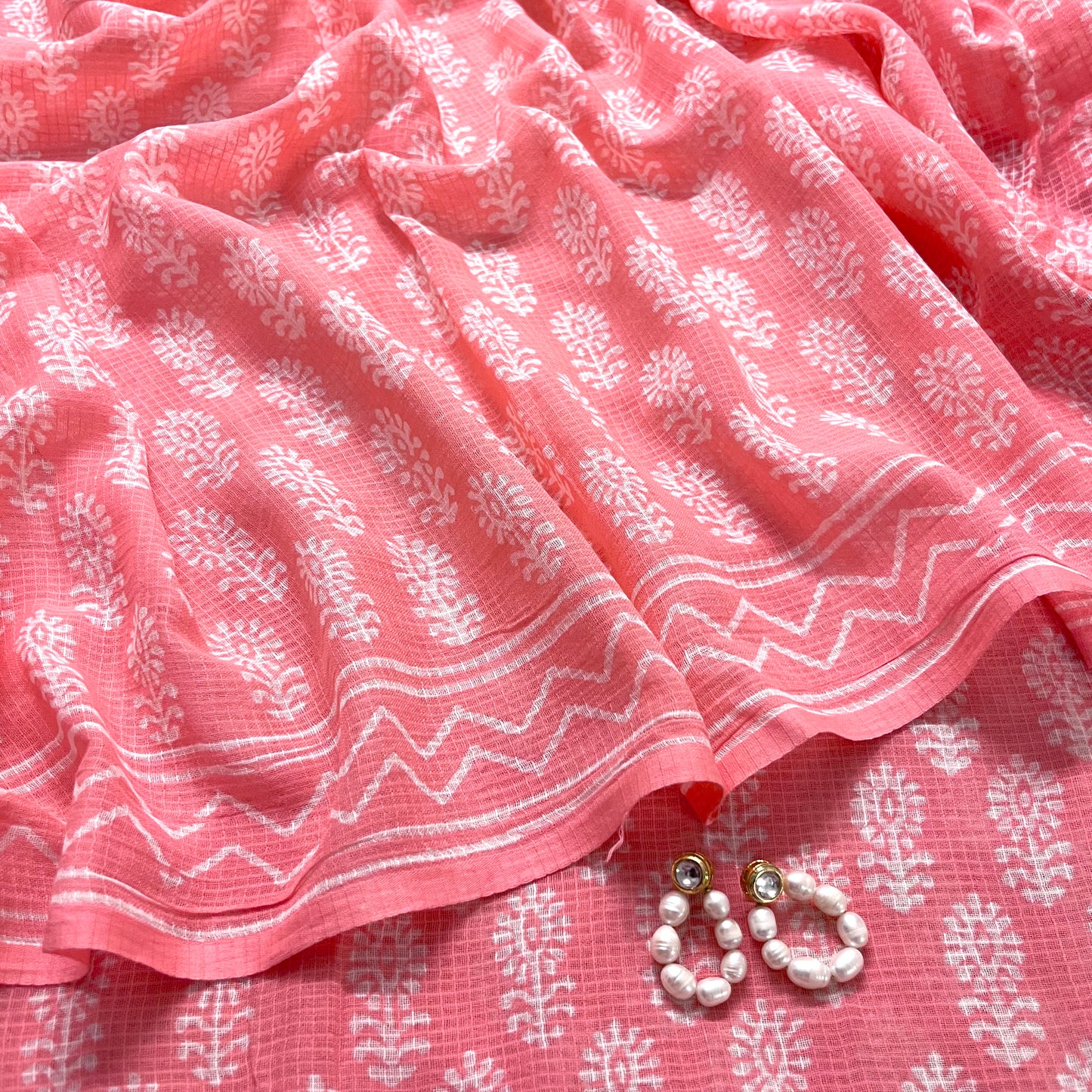 Peachish pink kota checks saree with block print all over