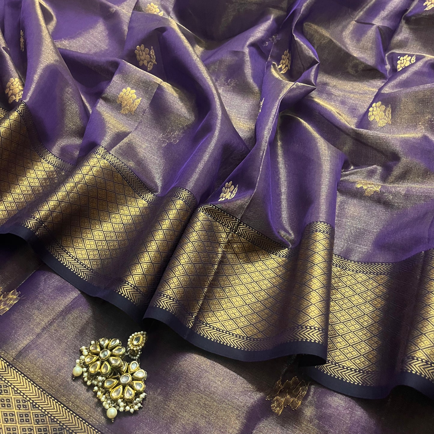 Dark purple maheshwari tissue silk saree with flower motifs all over