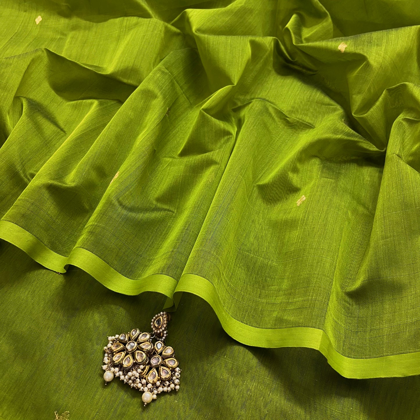 Olive green maheshwari saree with zari bootis all over