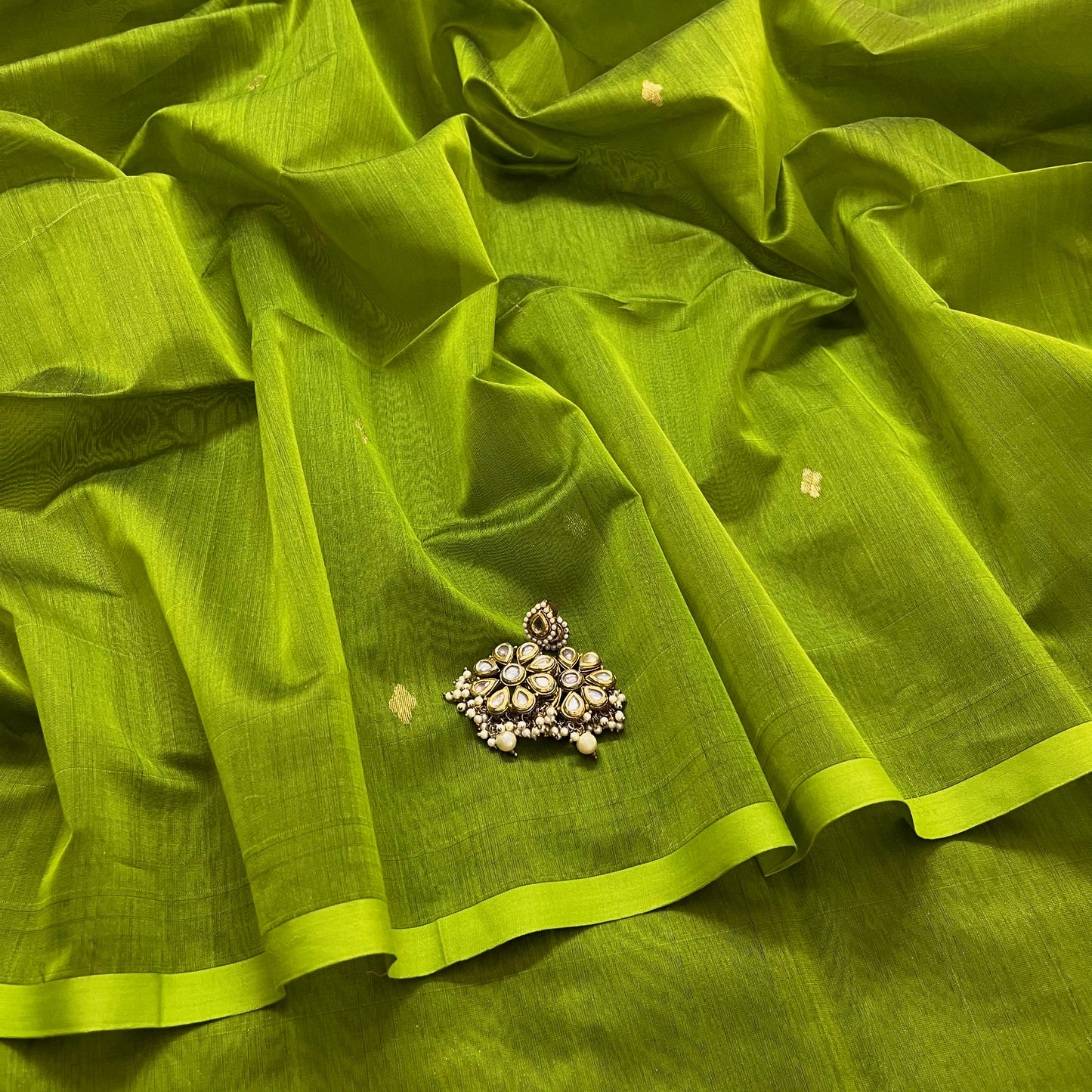Olive green maheshwari saree with zari bootis all over