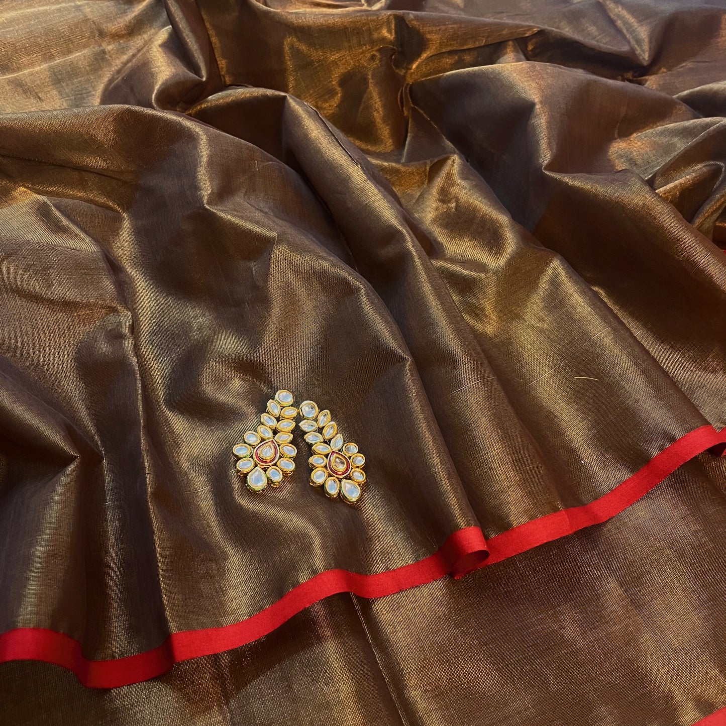 Bronze gold & red maheshwari tissue silk saree with zari lines on pallu