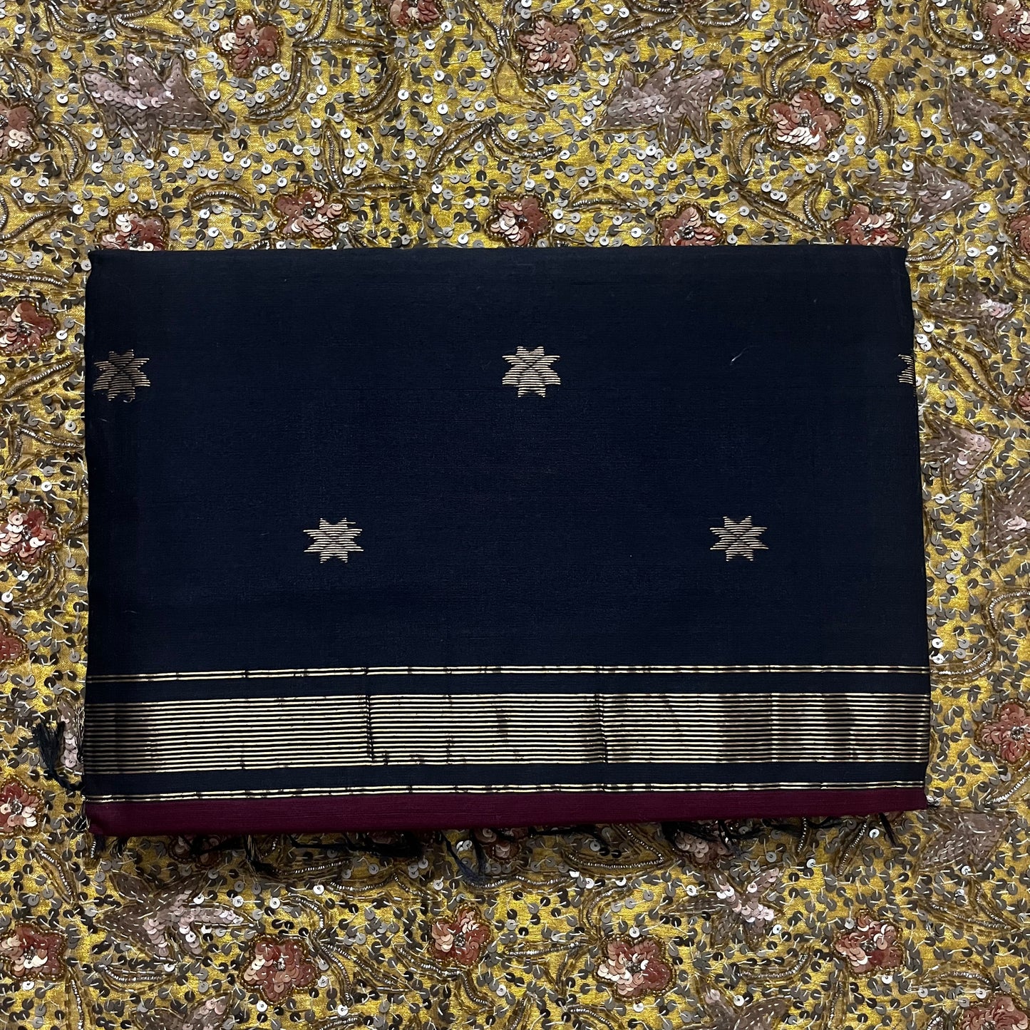 Maroon and black maheshwari saree with flower bootis all over