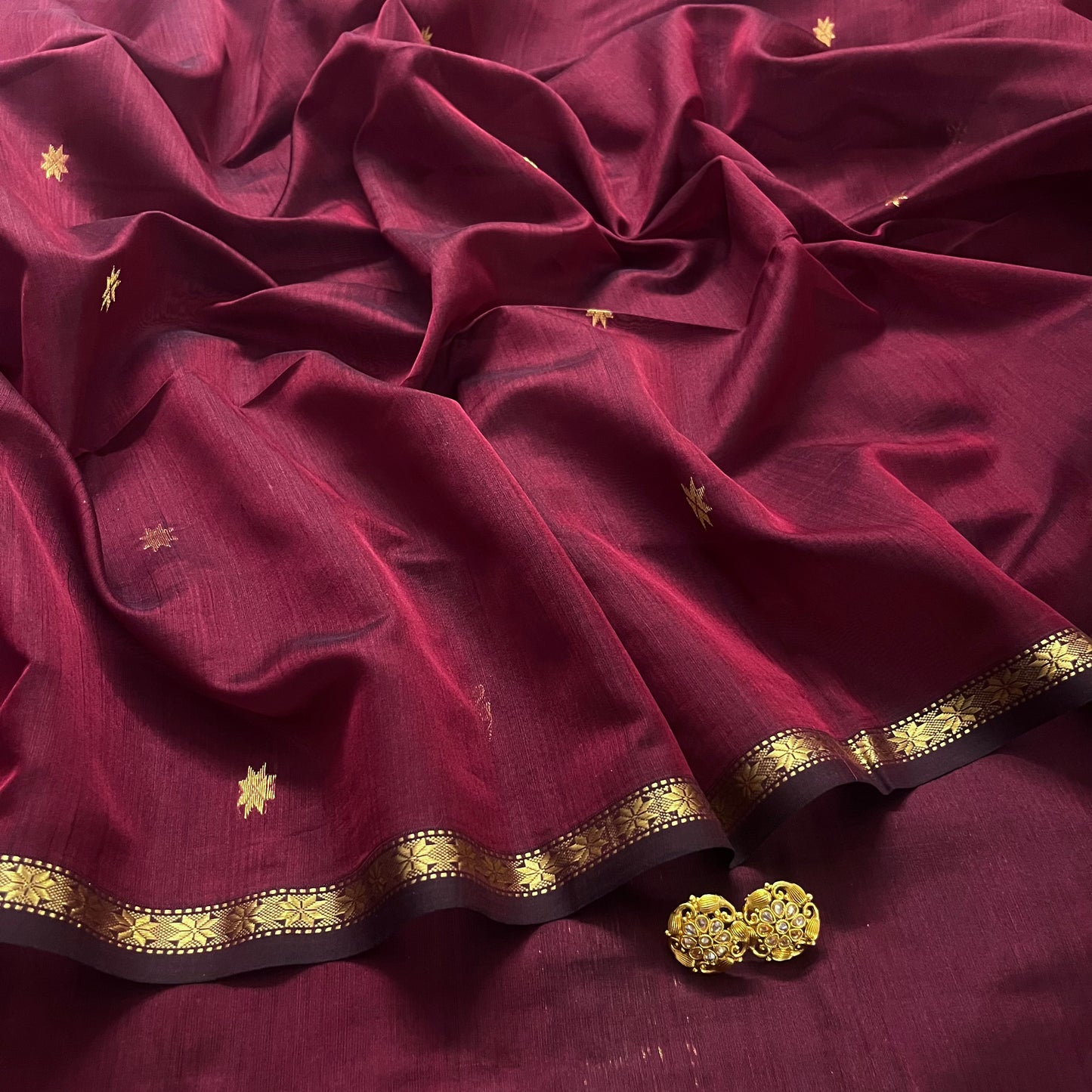 Maroon and black maheshwari saree with flower bootis all over
