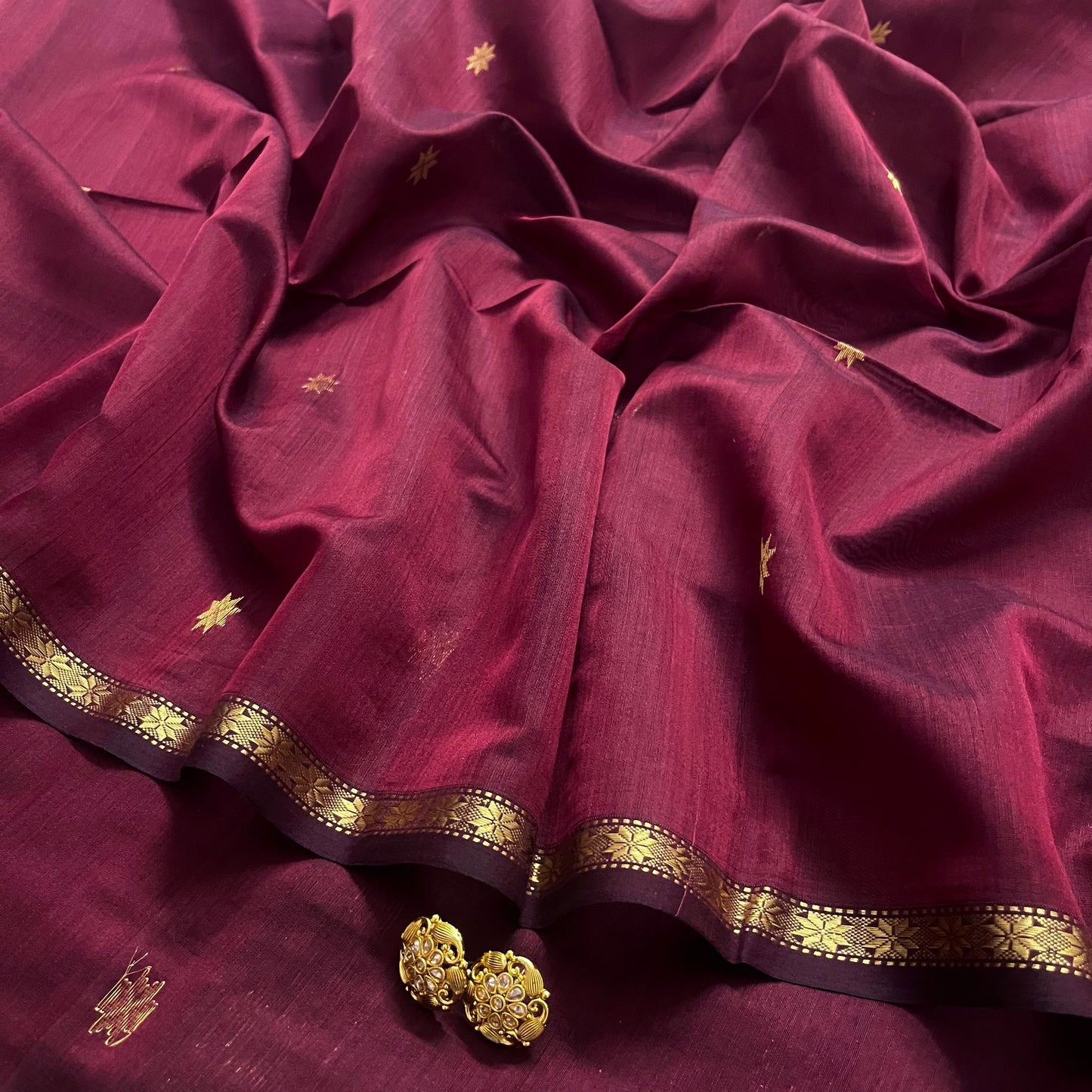 Maroon and black maheshwari saree with flower bootis all over