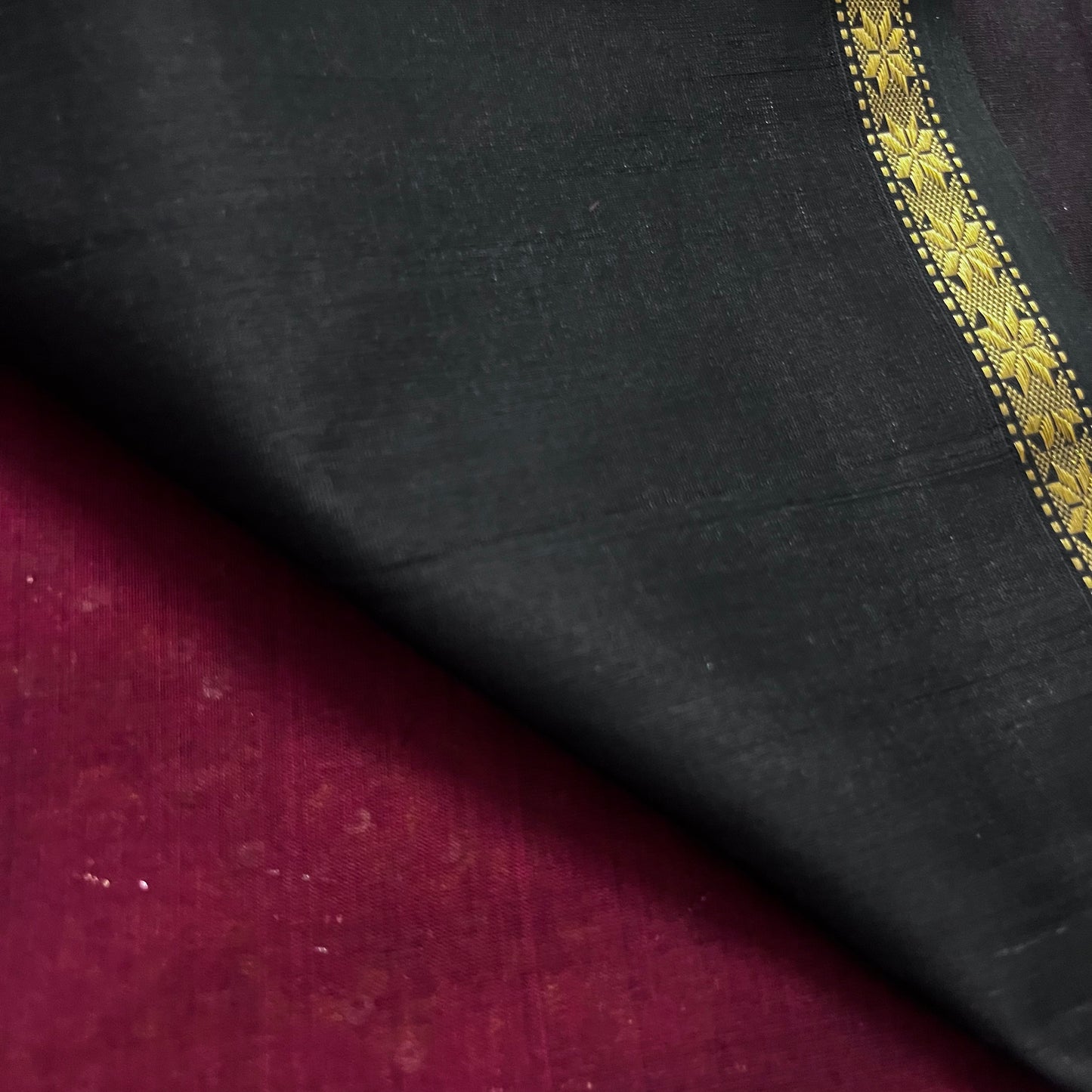 Maroon and black maheshwari saree with flower bootis all over