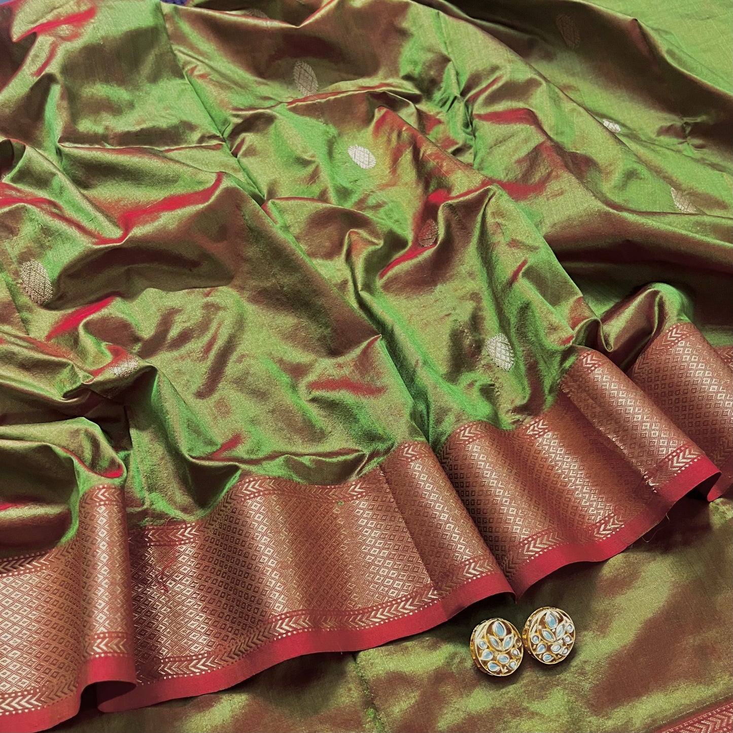 Olive green and red Maheshwari silk saree with zari bootis all over