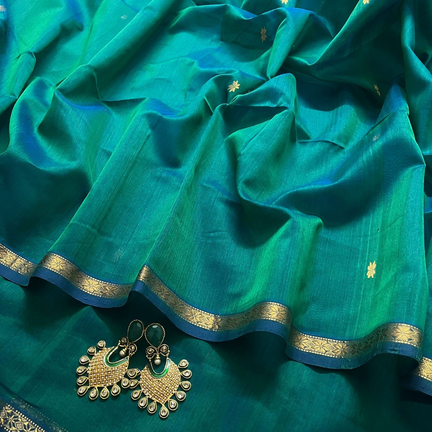 Peacock green dual tone maheshwari saree with flower bootis all over