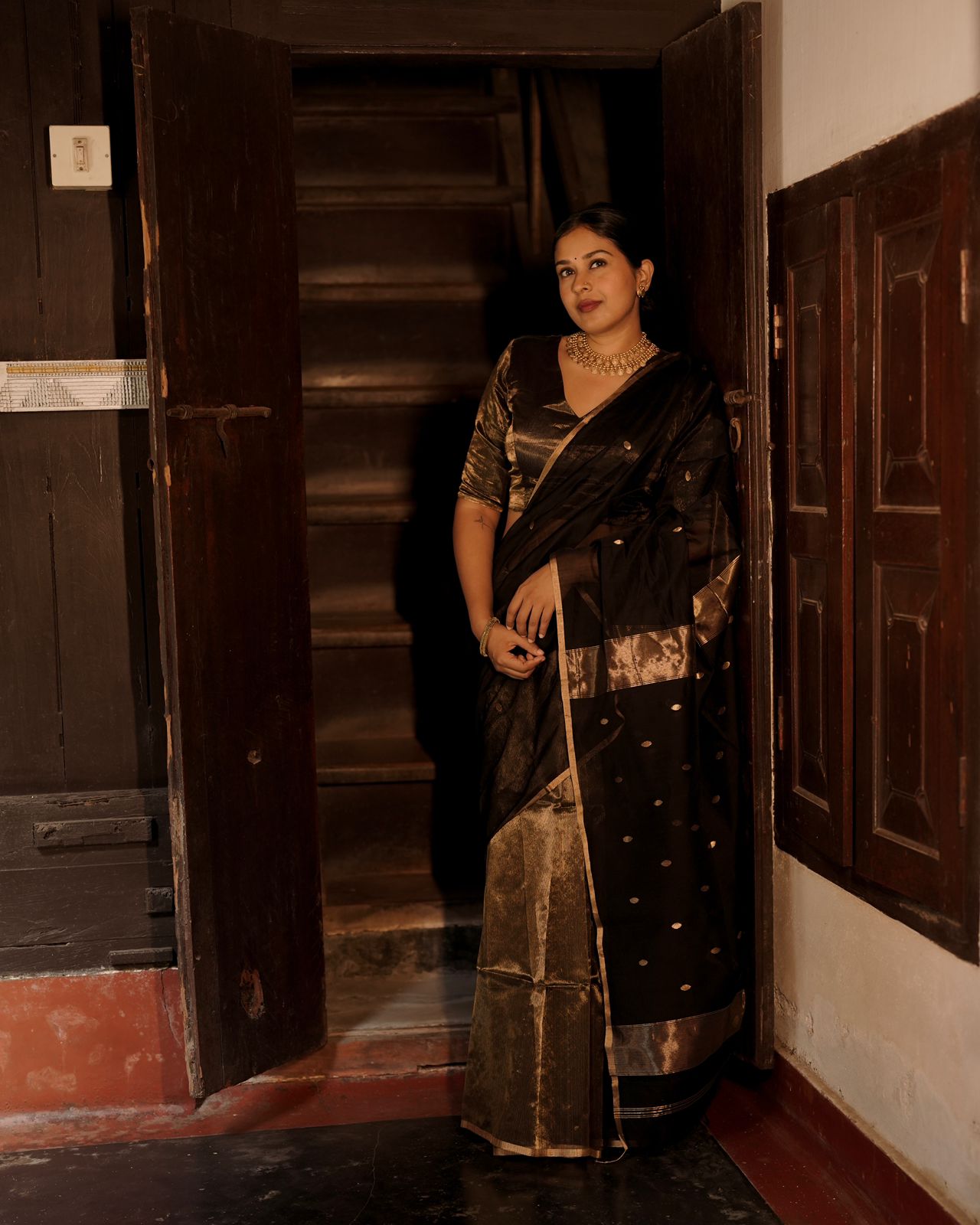 Black and gold maheshwari saree with zari bootis and zari lines all over
