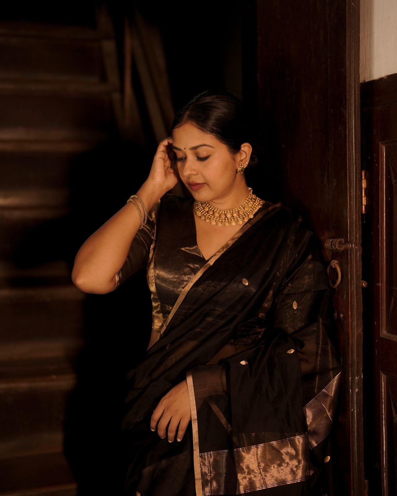 Black and gold maheshwari saree with zari bootis and zari lines all over