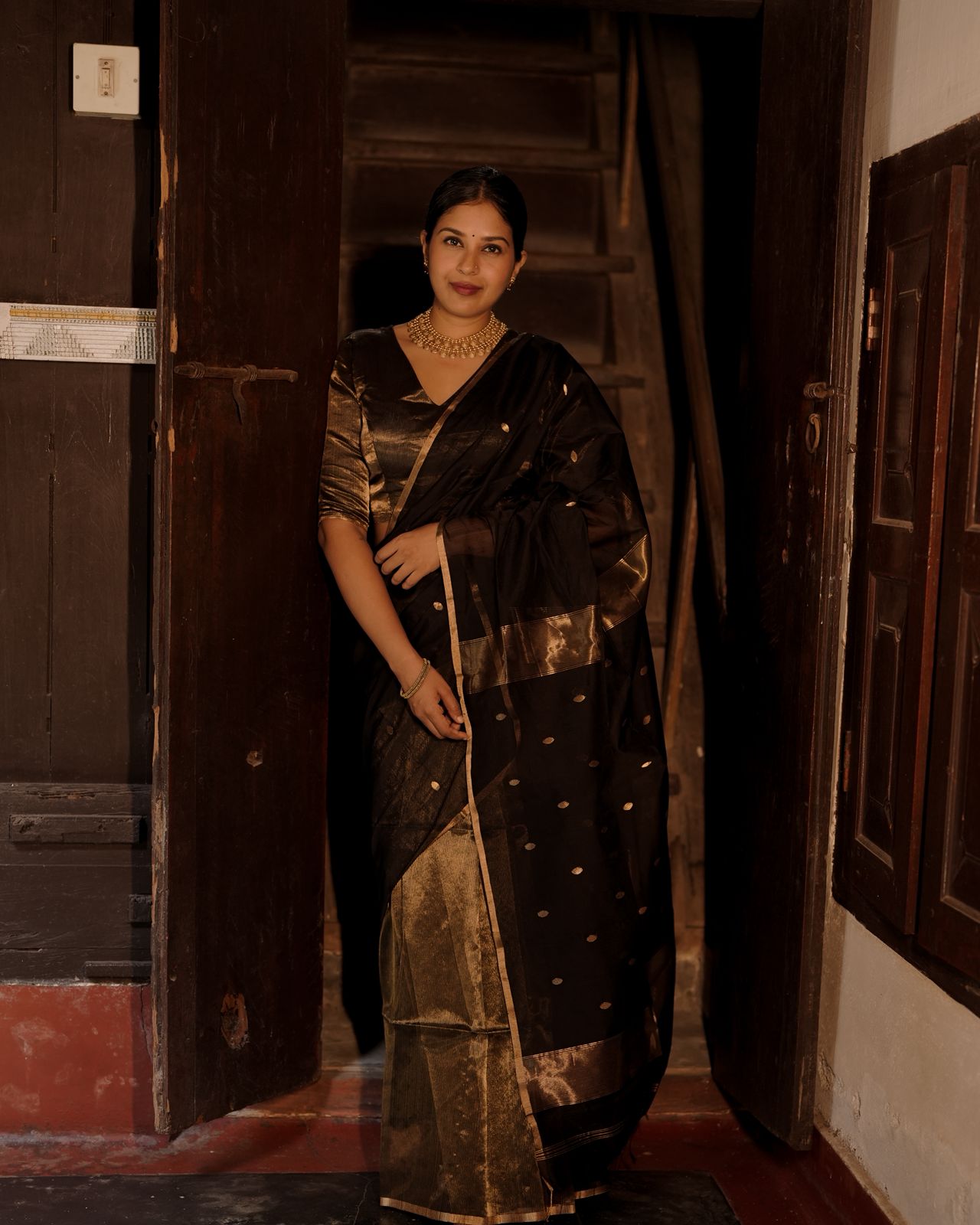 Black and gold maheshwari saree with zari bootis and zari lines all over