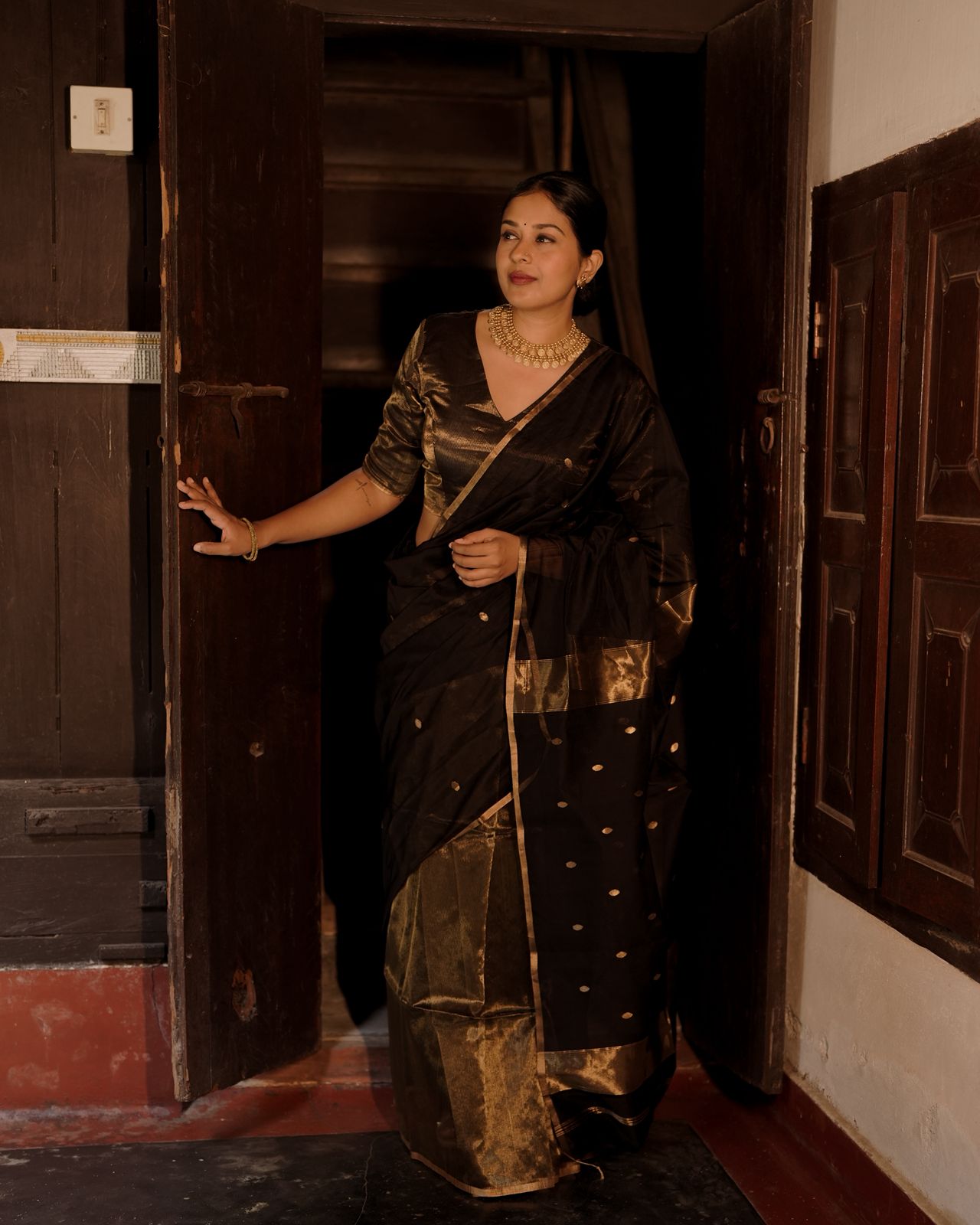 Black and gold maheshwari saree with zari bootis and zari lines all over
