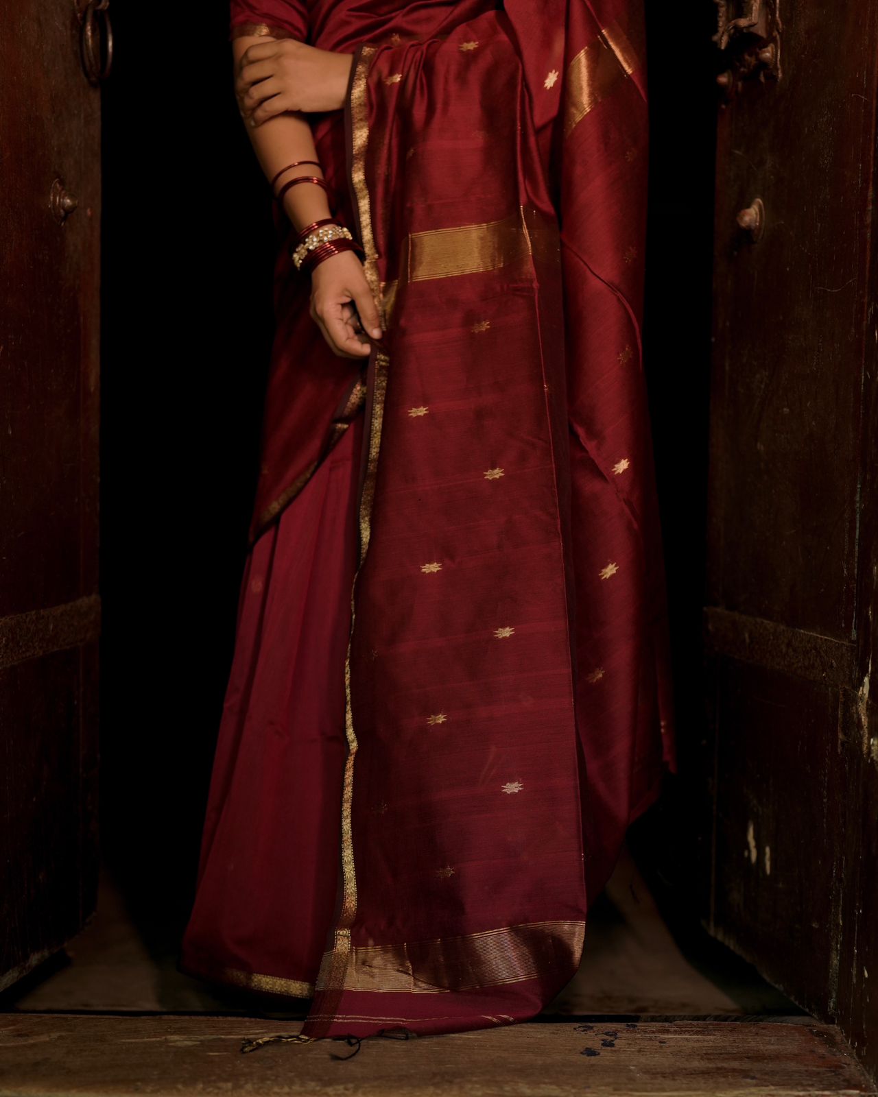 Deep maroon Maheshwari saree with flower bootis all over