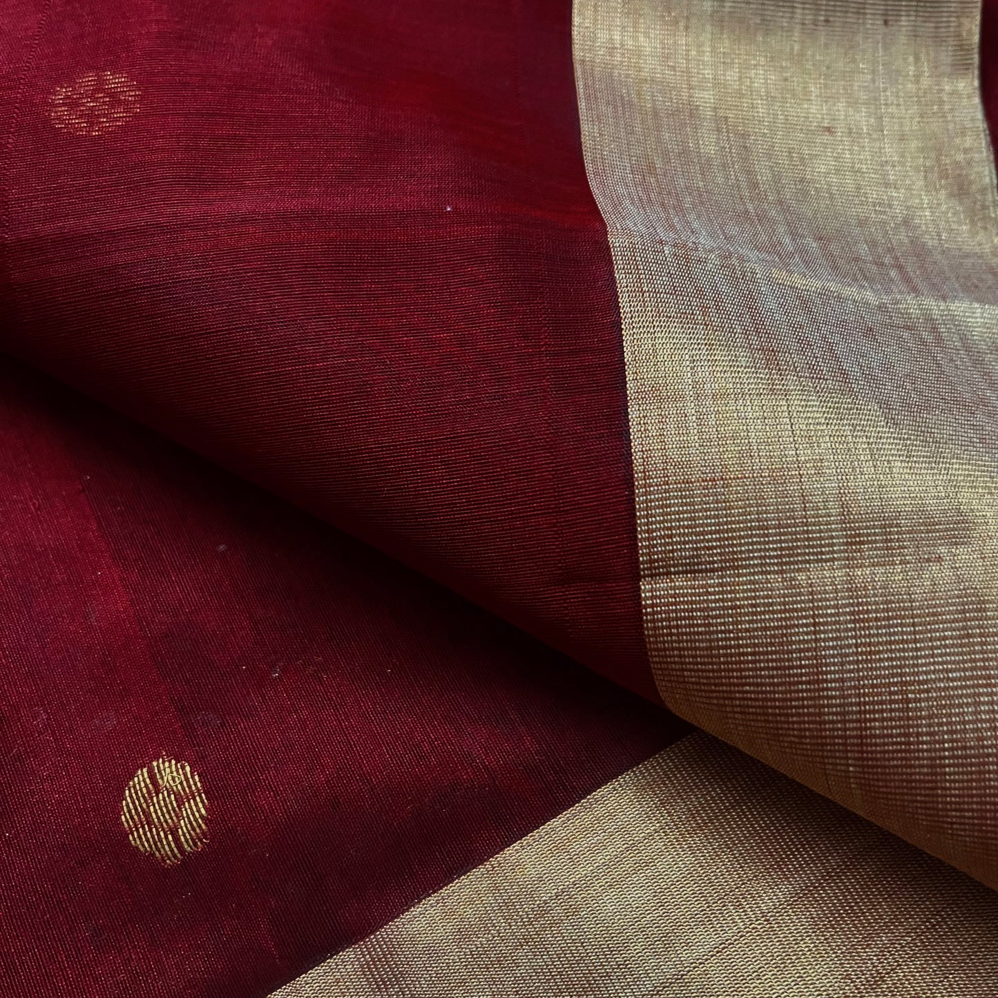 Deep maroon Chanderi saree with zari bootis all over and flower motifs on pallu