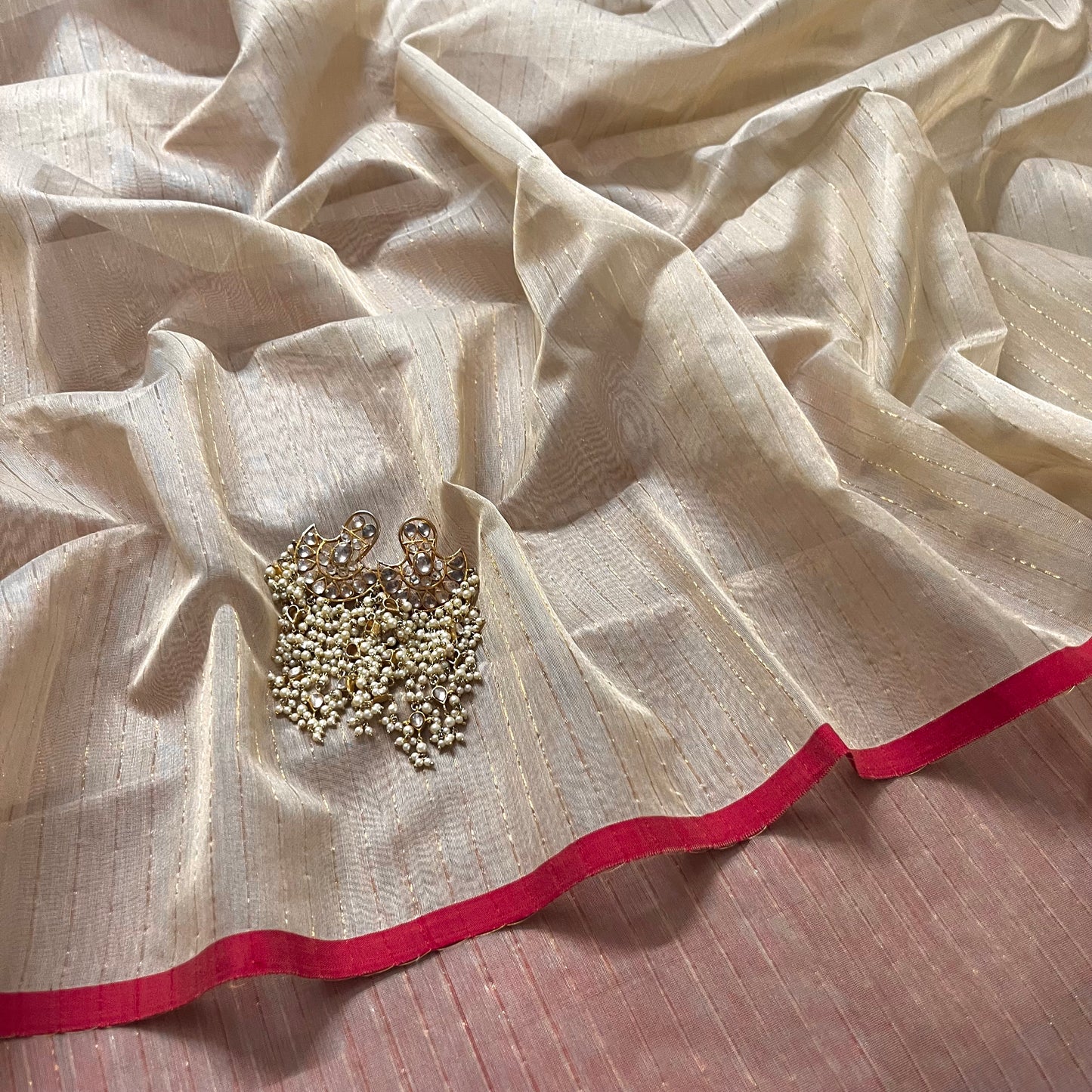 Light beige and red Maheshwari saree with zari lines all over