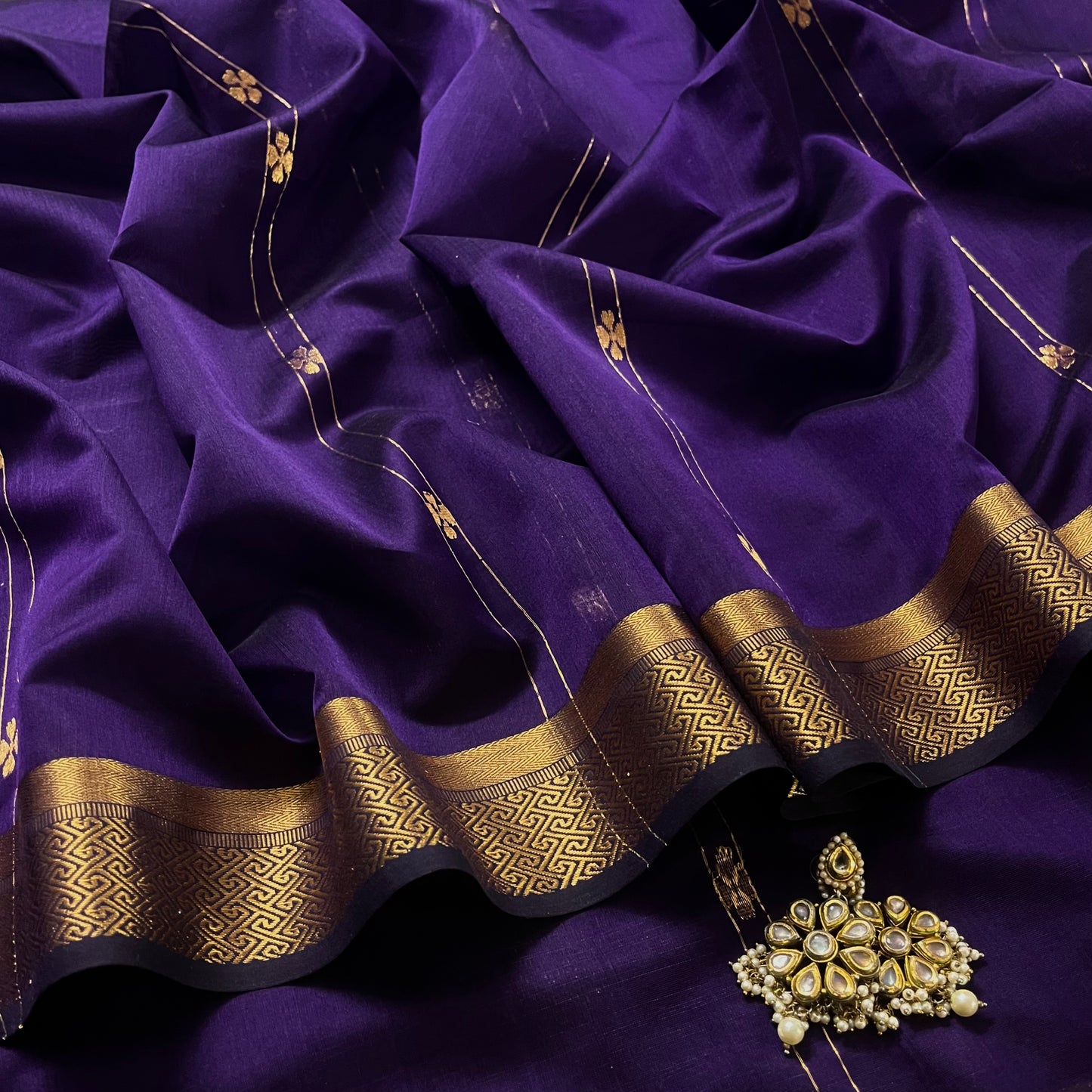 Dark purple Maheshwari saree with dori flower bootis all over
