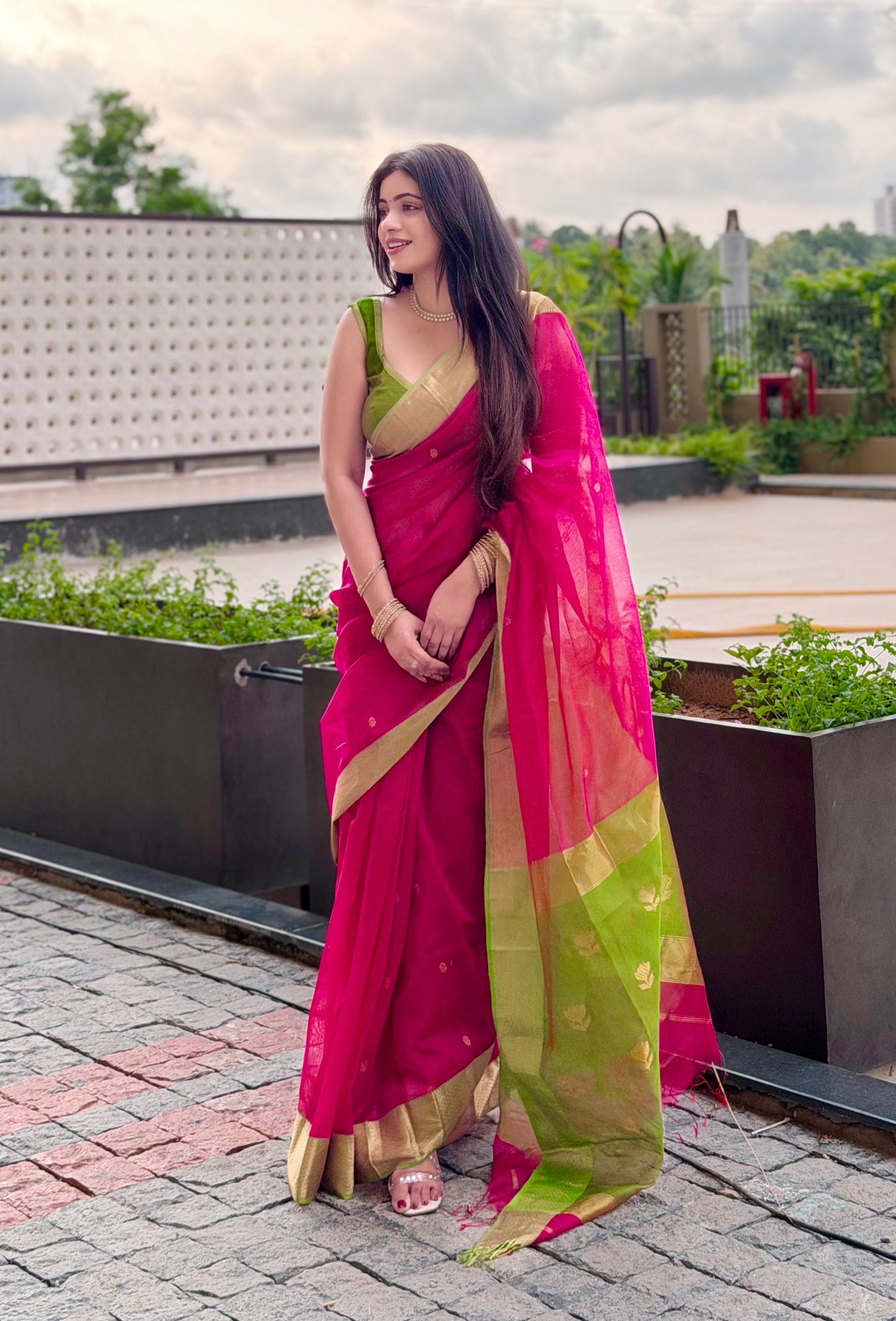 Pink and olive green Maheshwari saree with flower motifs on pallu