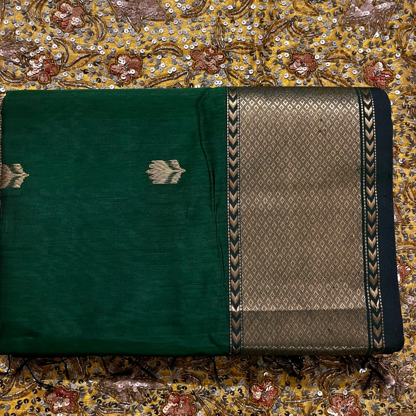 Dark green Maheshwari saree with flower motifs all over