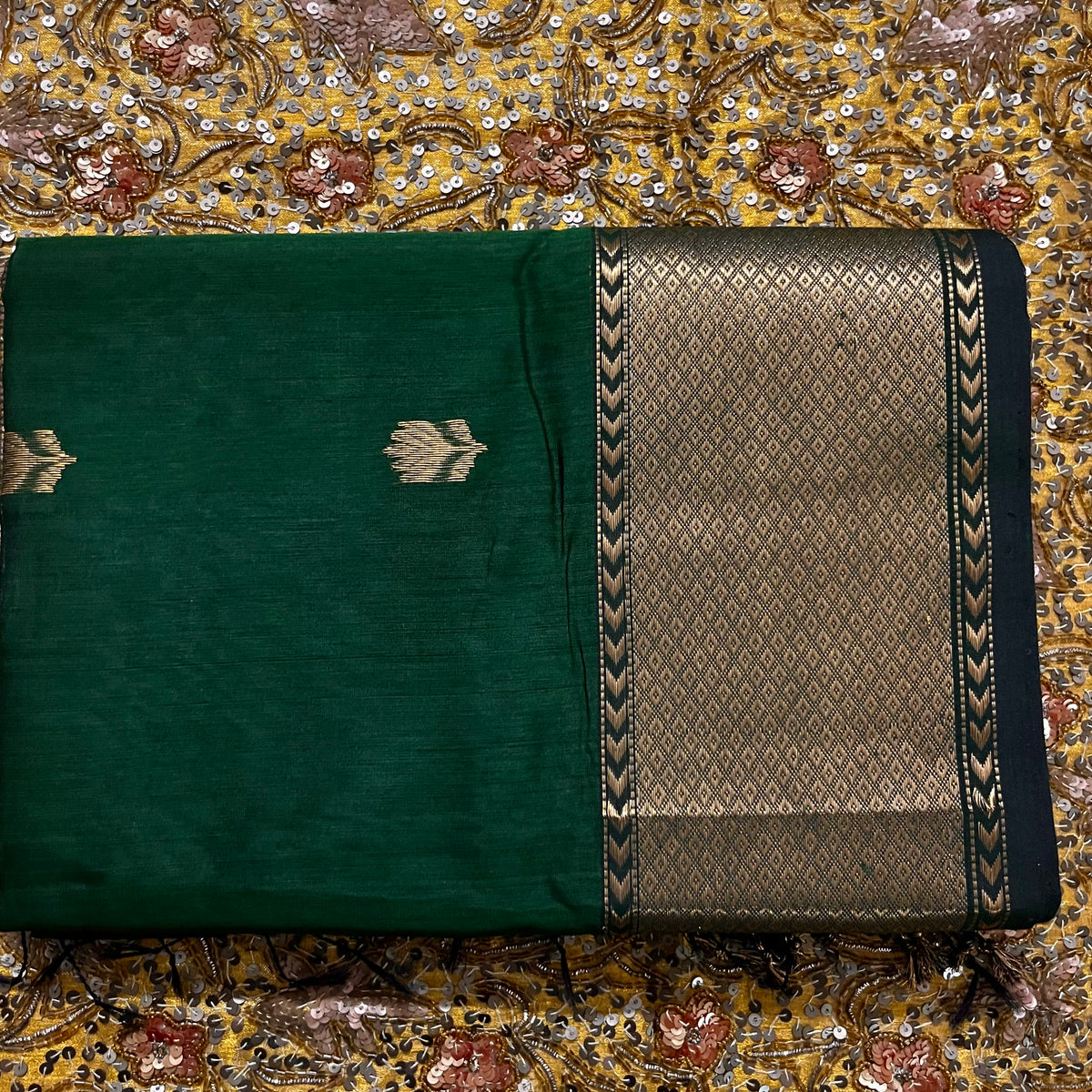 Dark green Maheshwari saree with flower motifs all over