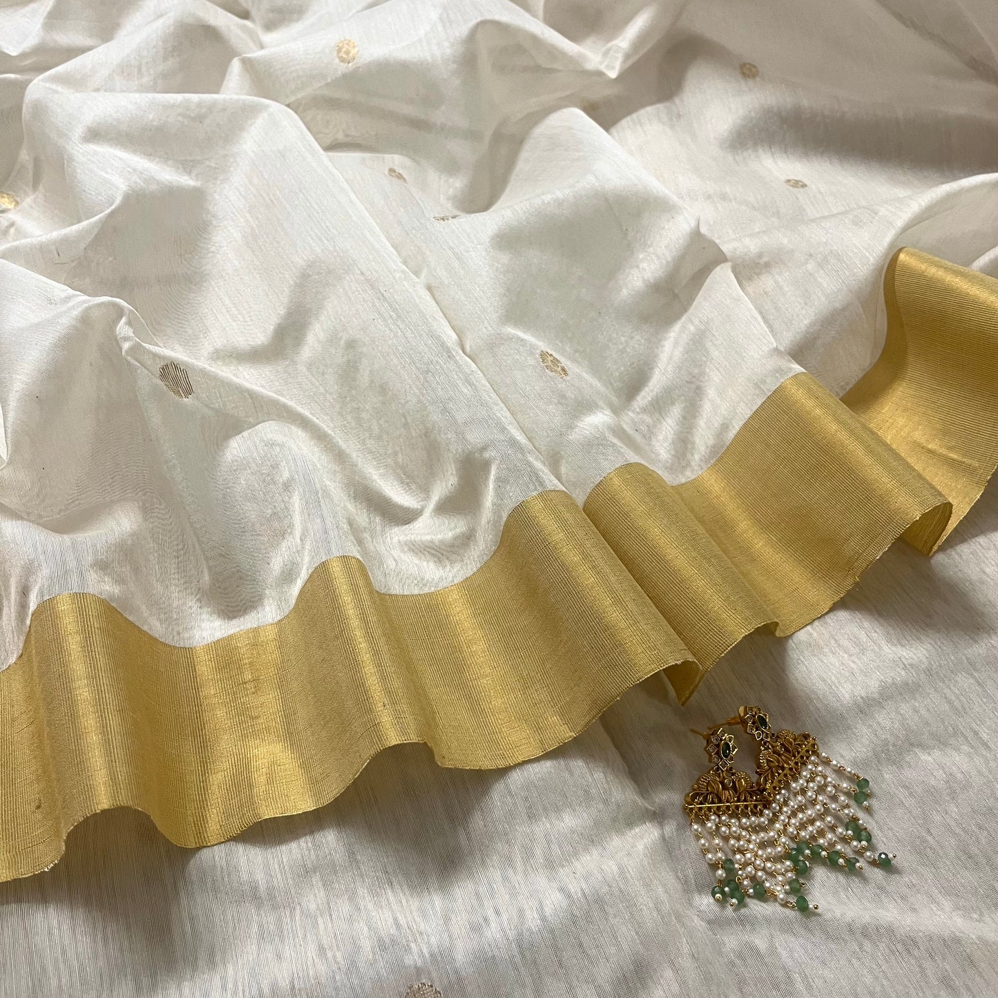 Off white Chanderi saree with zari bootis all over and zari motifs on pallu