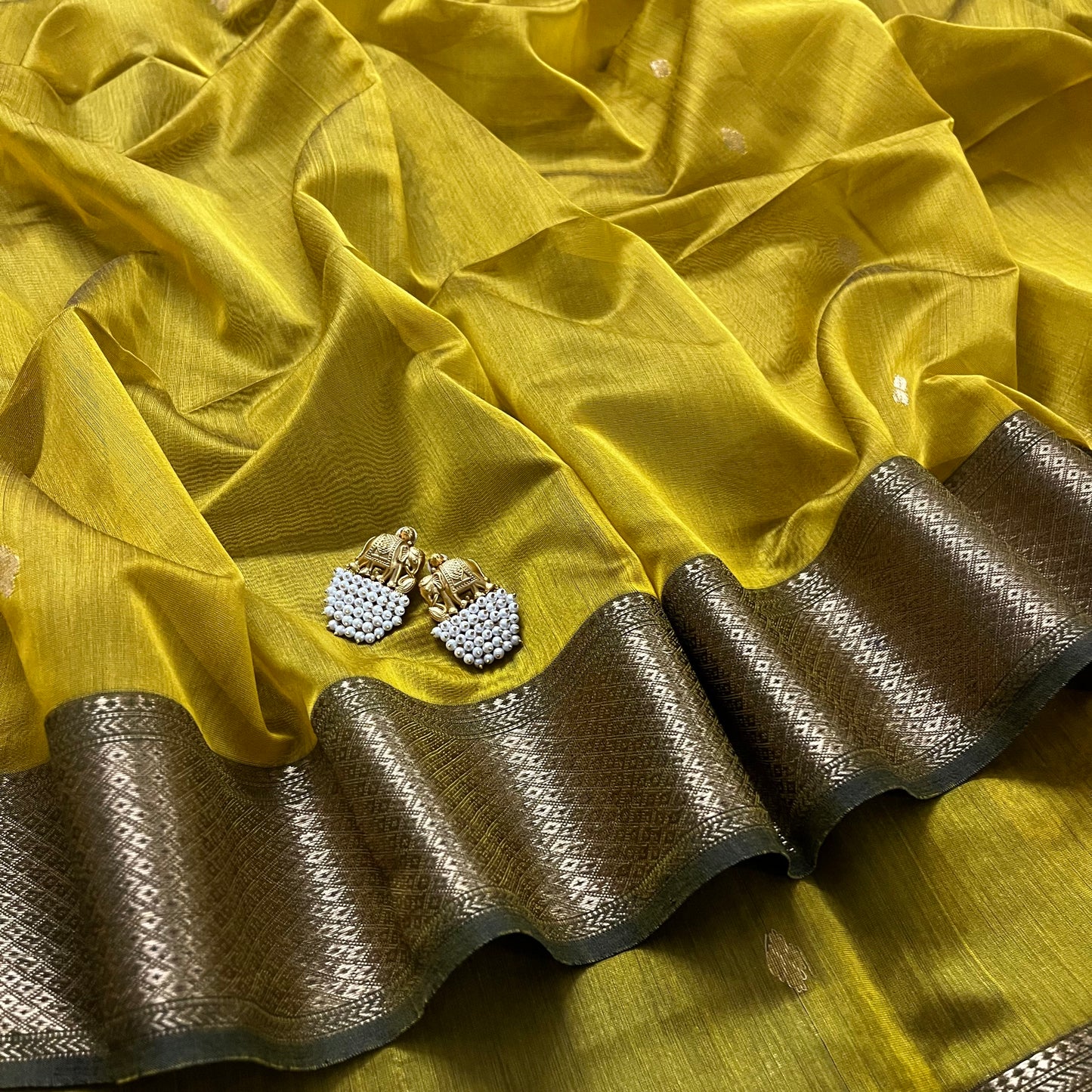 Mustard and green Maheshwari saree with flower motifs on pallu