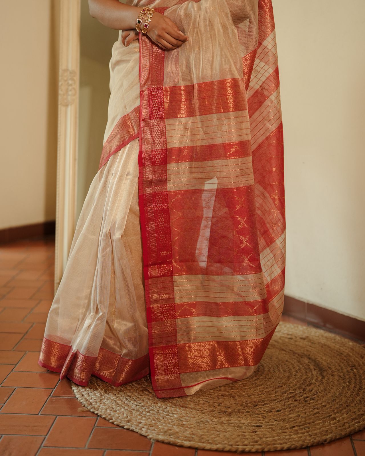 Cream and red Maheshwari tissue silk saree with zari pattern on pallu