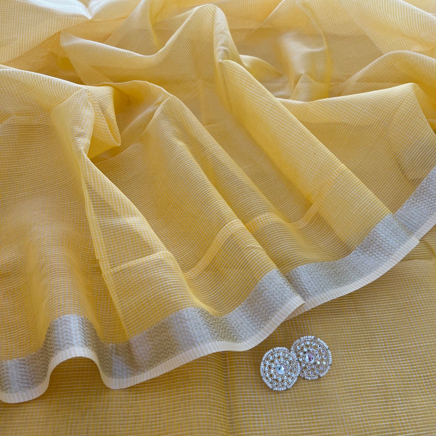 Yellow Maheshwari saree with silver zari border