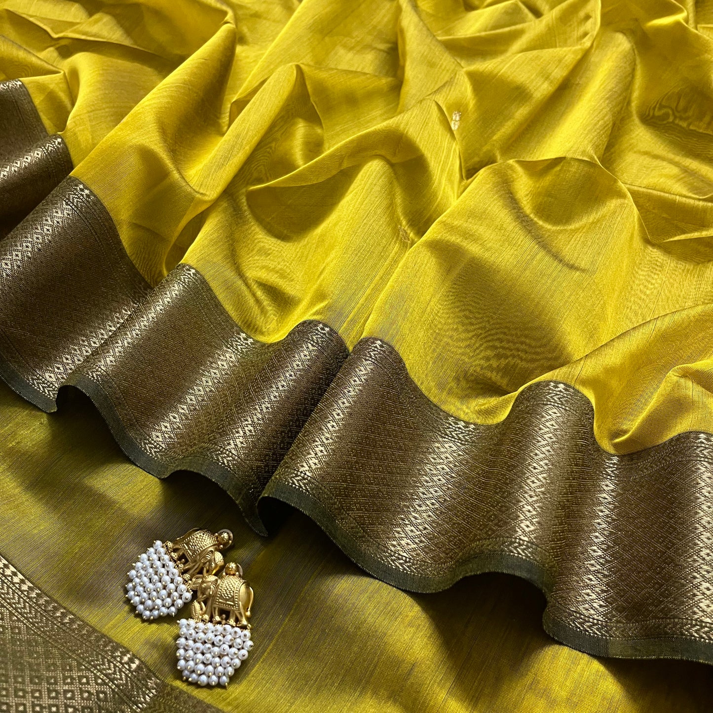 Mustard and green Maheshwari saree with flower motifs on pallu