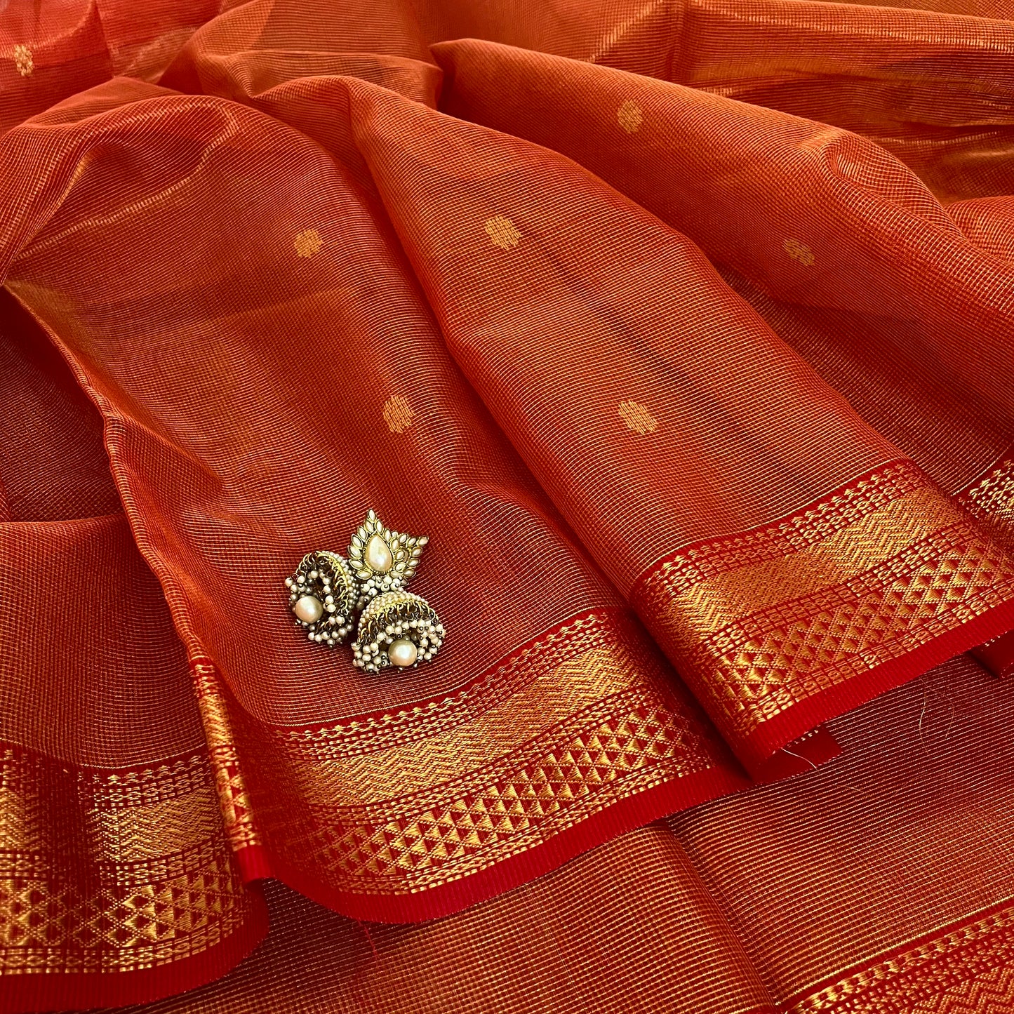 Red and gold Maheshwari silk saree with zari jaal work on pallu