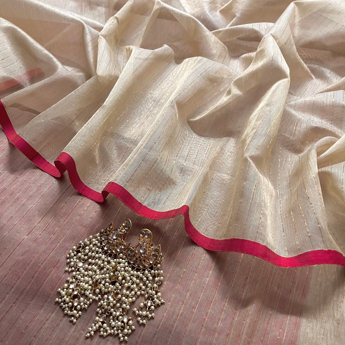 Light beige and red Maheshwari saree with zari lines all over