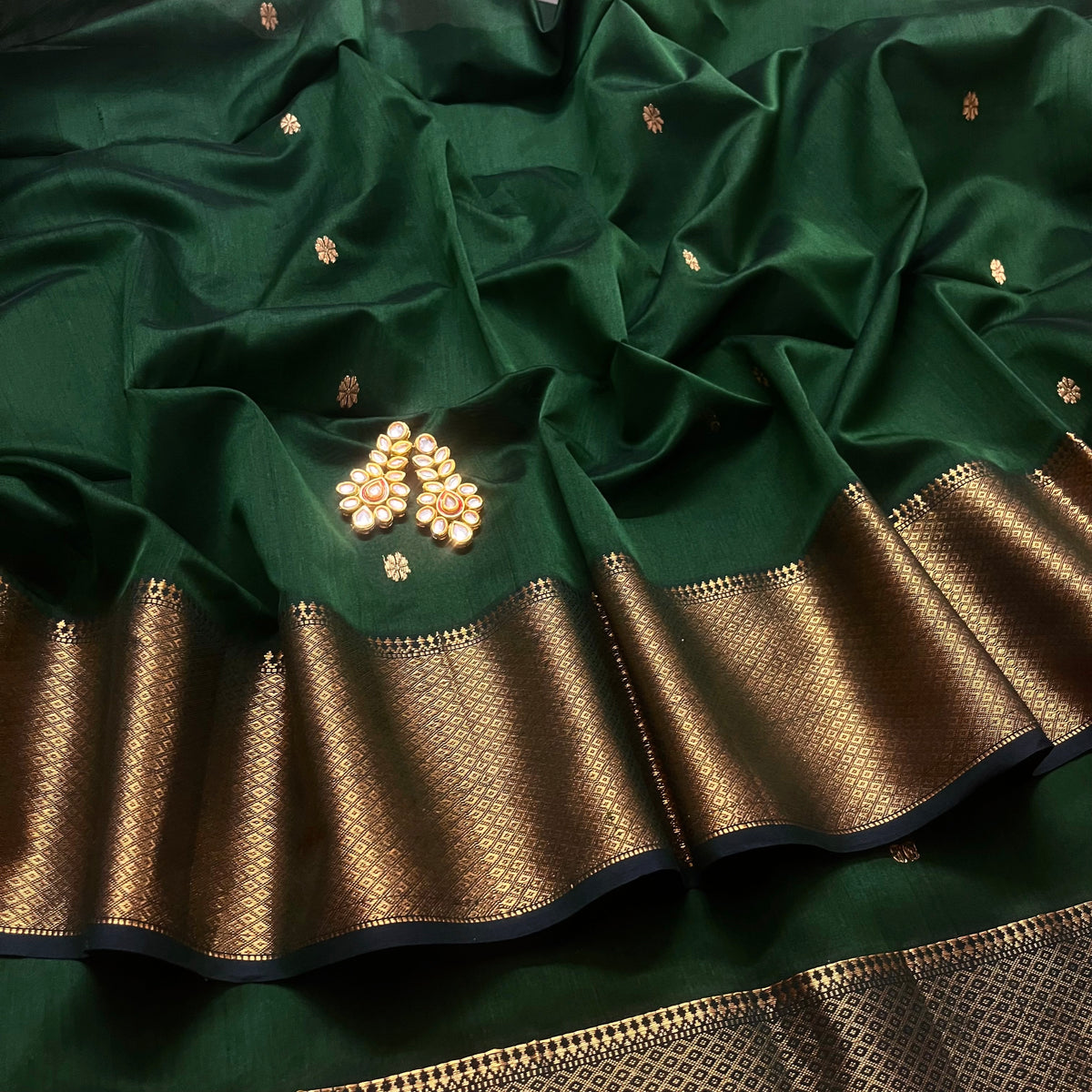 Dark green maheshwari with saree with flower bootis all over