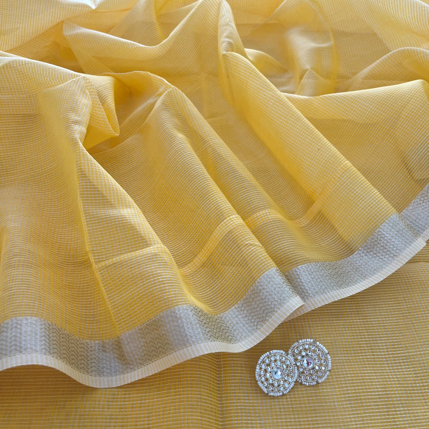 Yellow Maheshwari saree with silver zari border