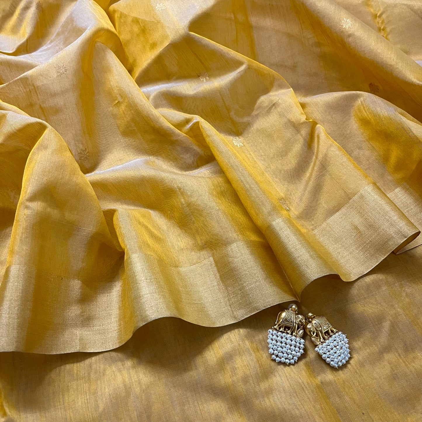 Mustard yellow Chanderi saree with zari bootis all over and flower motifs on pallu
