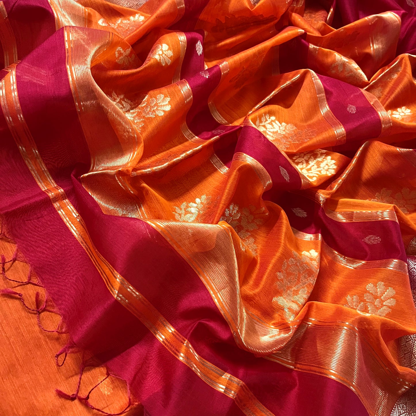 Red and orange Maheshwari saree with zari motifs on pallu