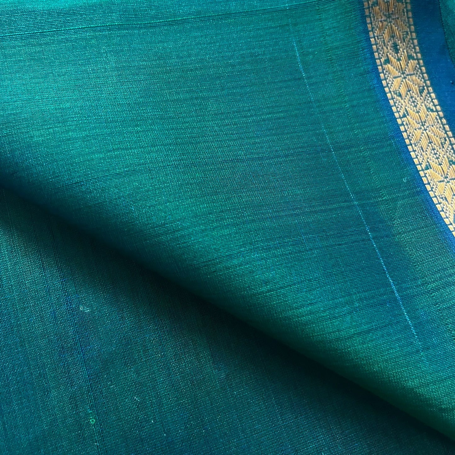 Peacock green and blue Maheshwari saree with zari border and zari bootis all over