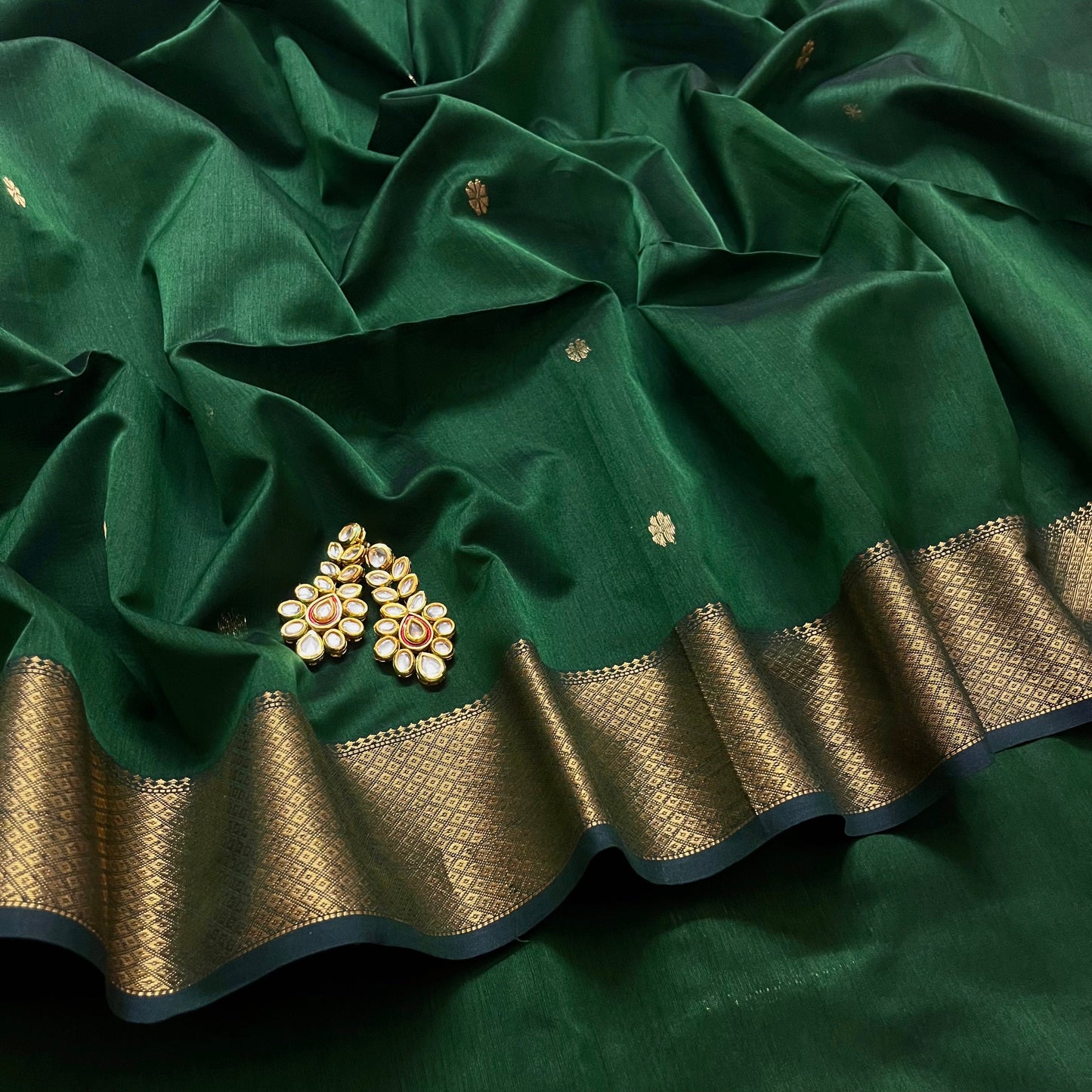 Dark green maheshwari with saree with flower bootis all over