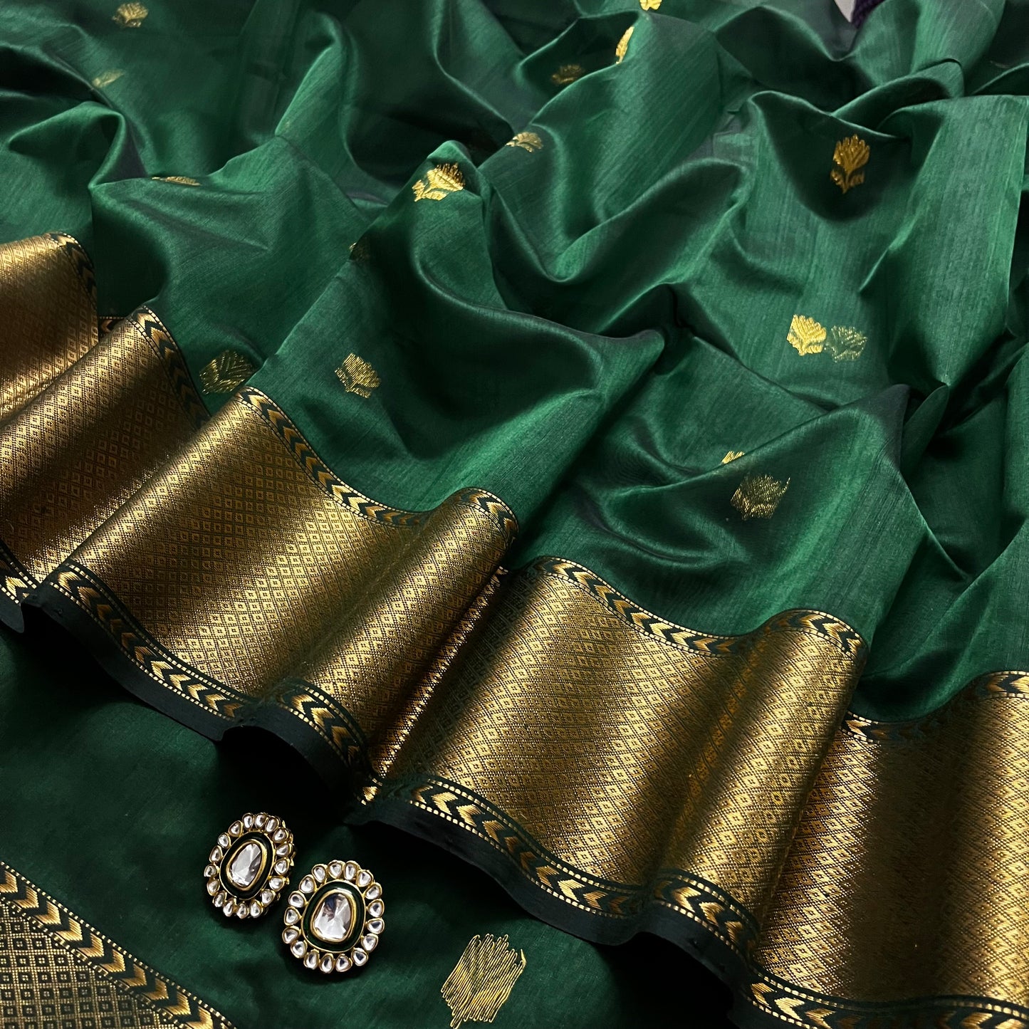 Dark green Maheshwari saree with flower motifs all over