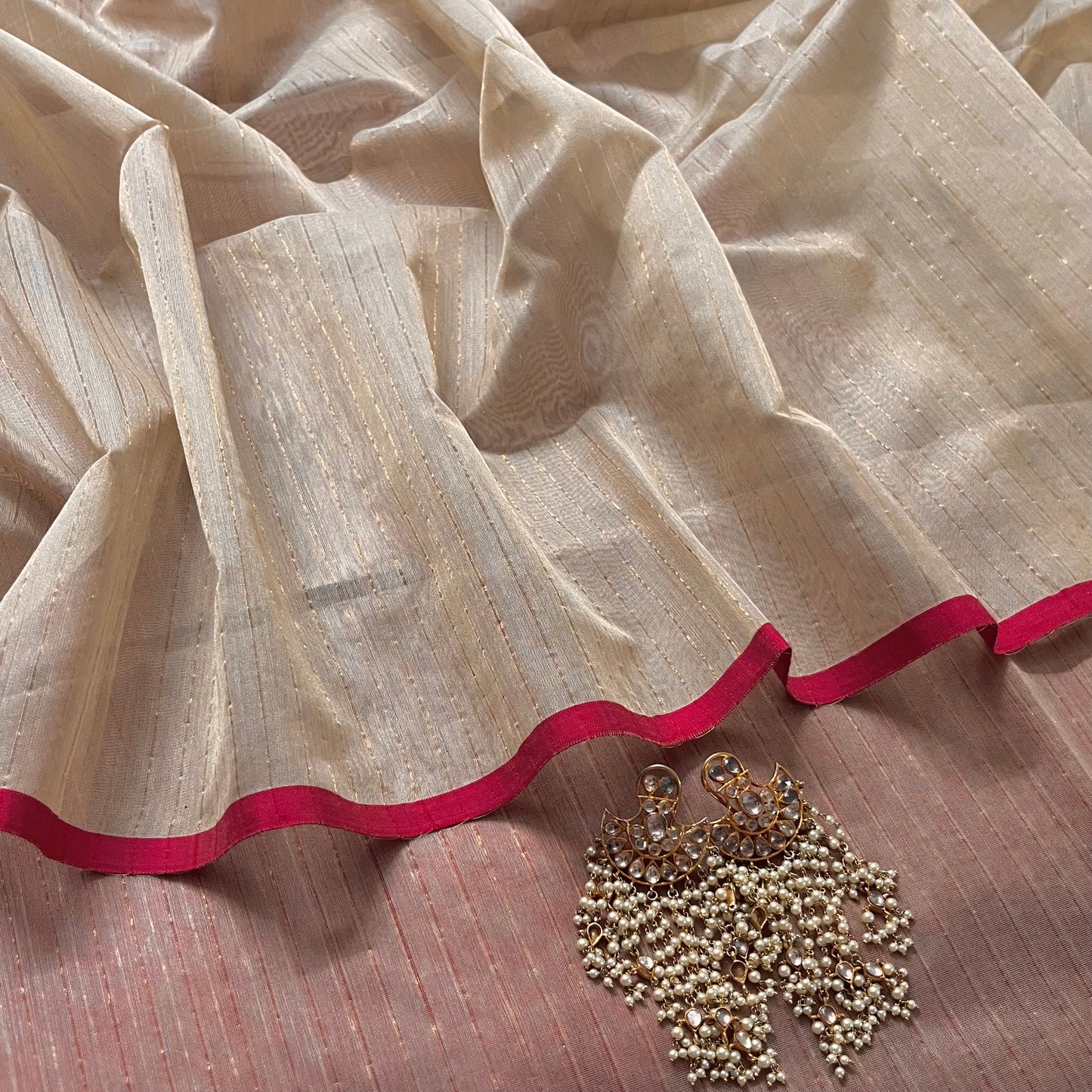 Light beige and red Maheshwari saree with zari lines all over