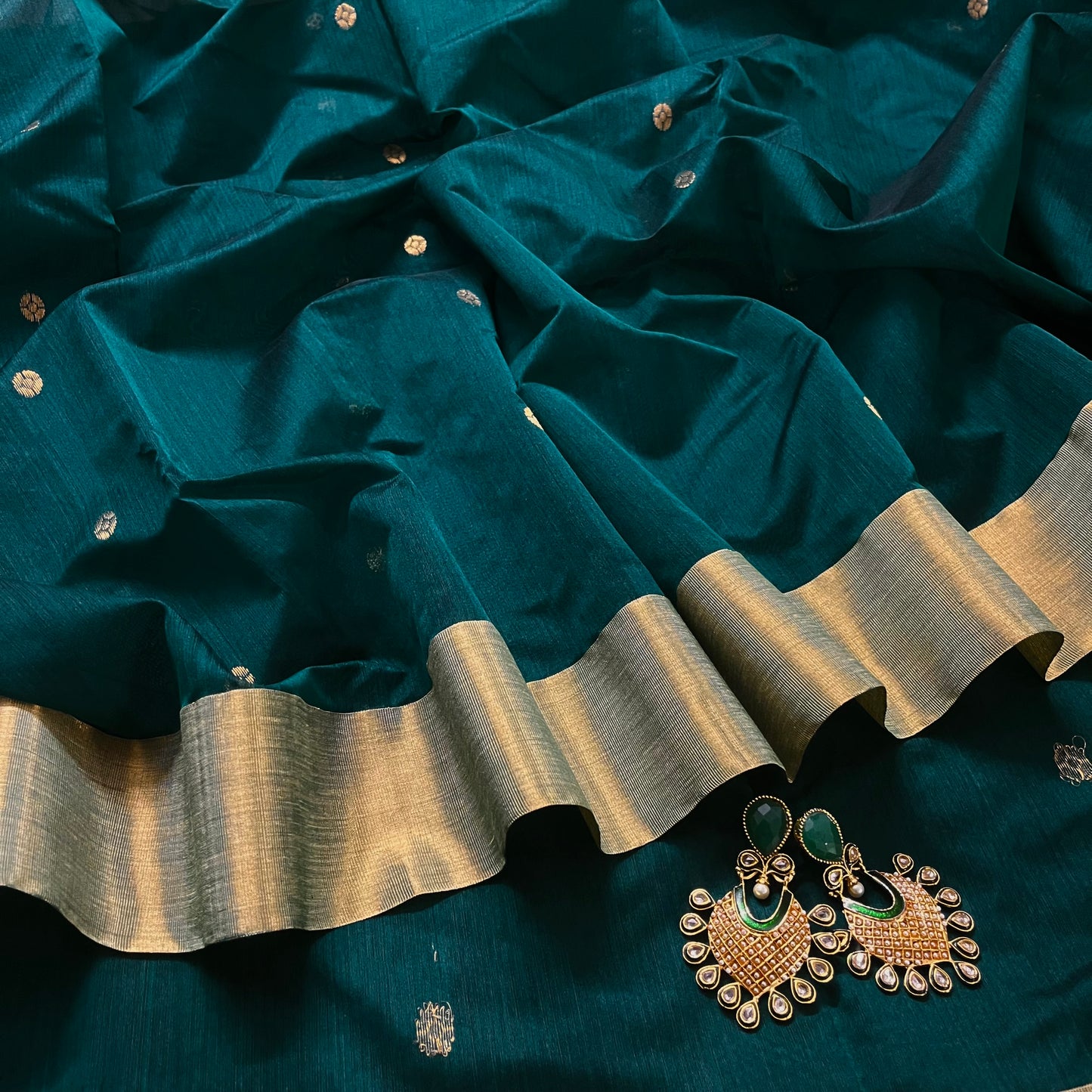 Teal Chanderi saree with zari bootis all over and flower motifs on pallu