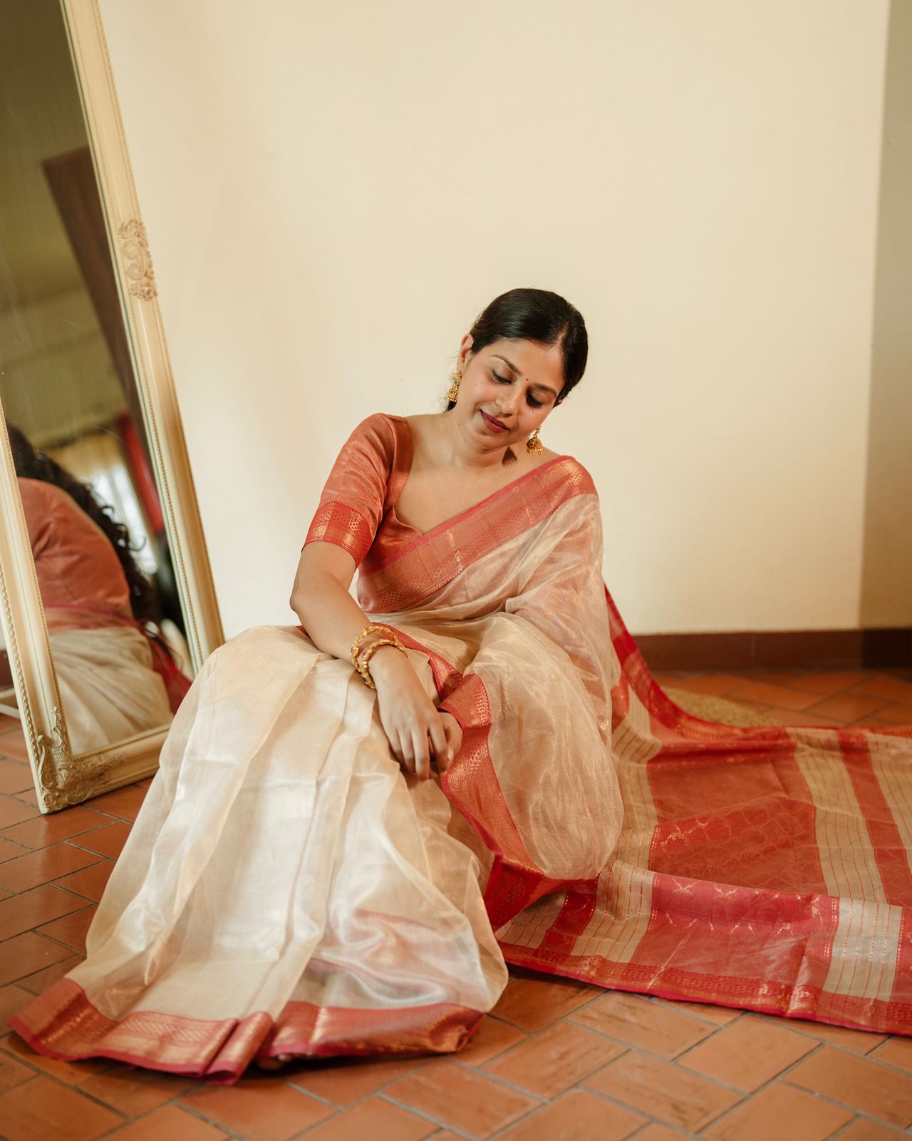 Cream and red Maheshwari tissue silk saree with zari pattern on pallu