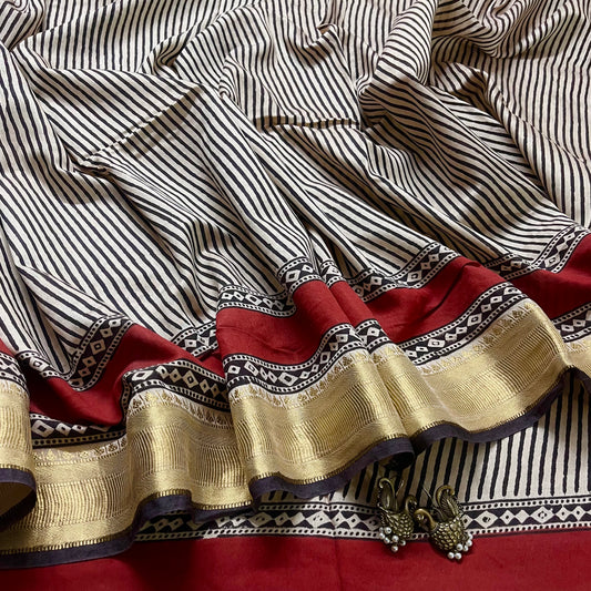 Black and white silk saree with block print all over and zari border